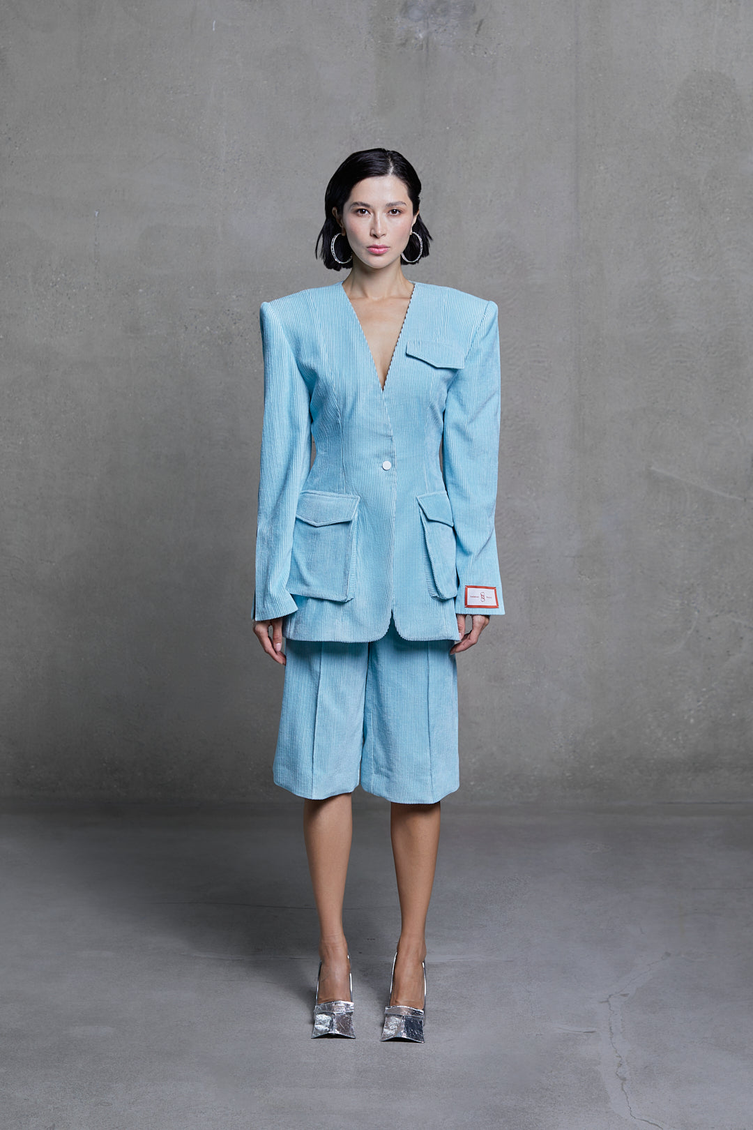 Azure velvet bermuda shorts and matching jacket, front view on model.