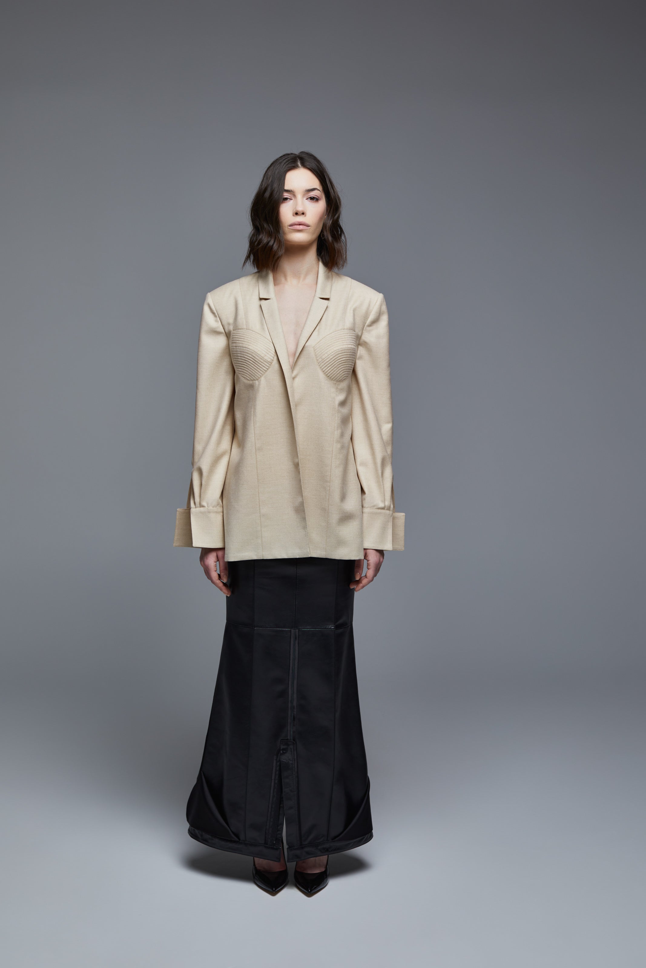 Beige wool designer shirt front view with sculpted bust seam detail on model