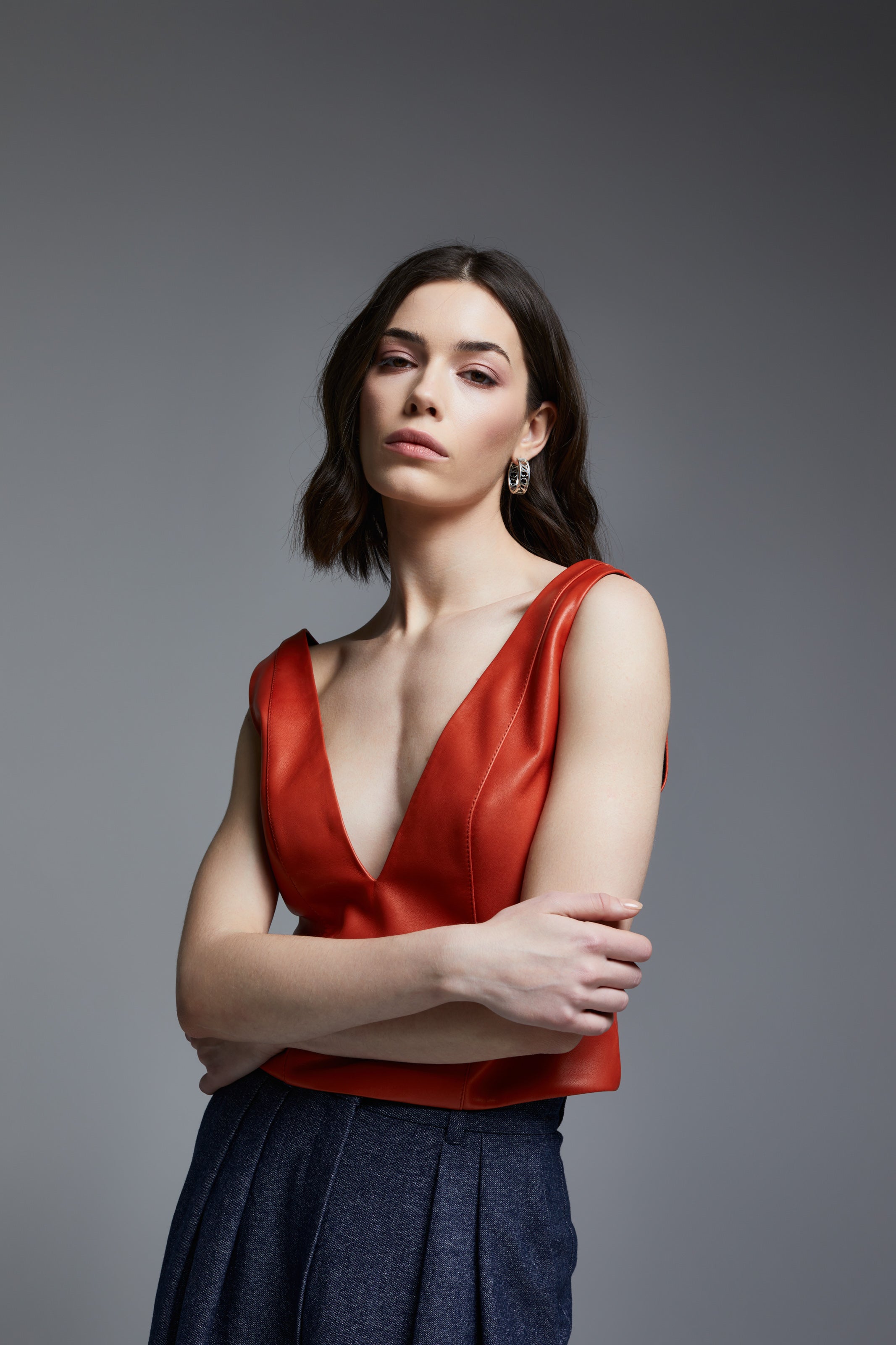 inger Red Leather Top styled with wide-leg navy trousers, close-up front view