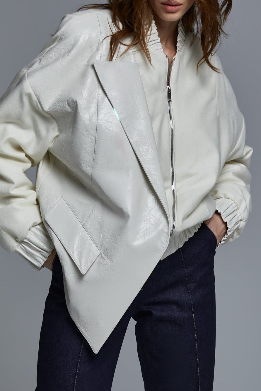 White cashmere and leather bomber jacket close-up with asymmetrical panel detail