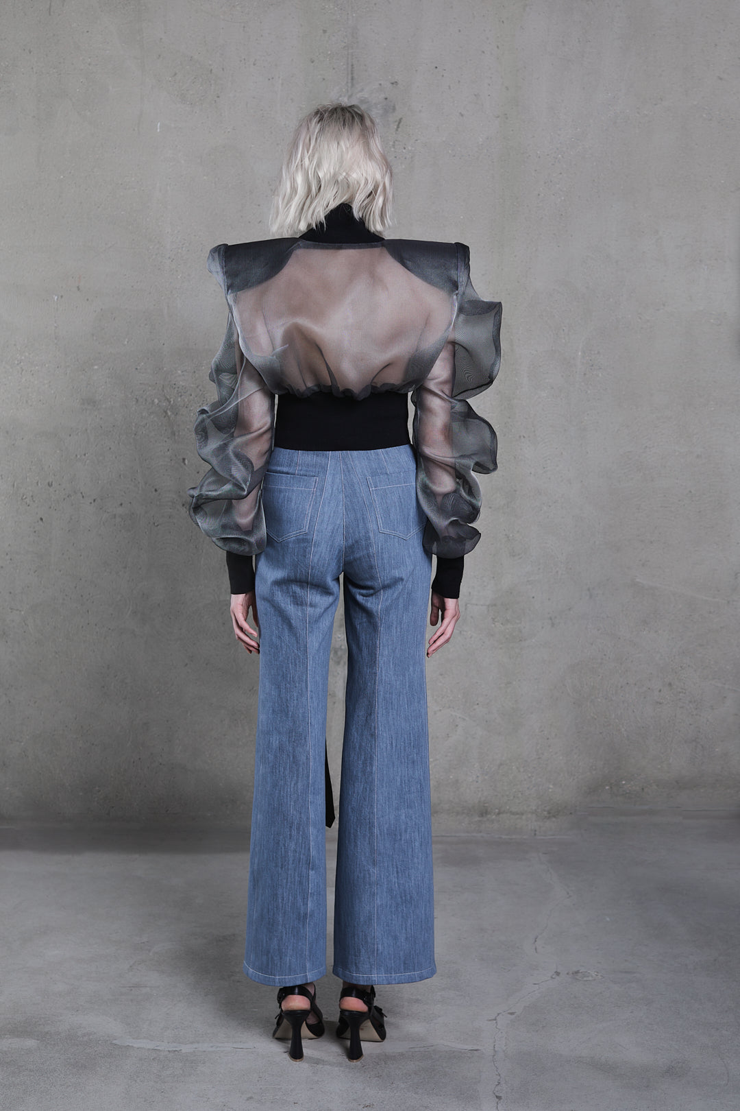 Back view, high-waist denim trousers with rear seam and slit