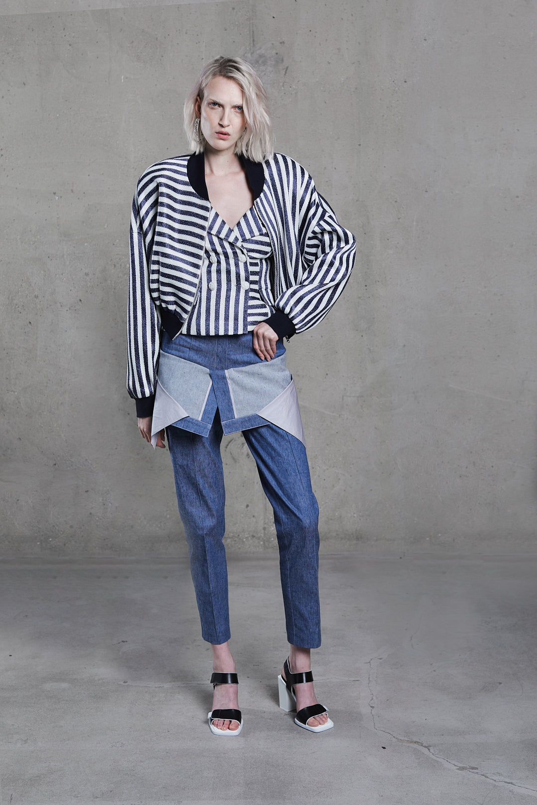 Cropped striped raffia bomber jacket in navy/white, angled front view, volume sleeves