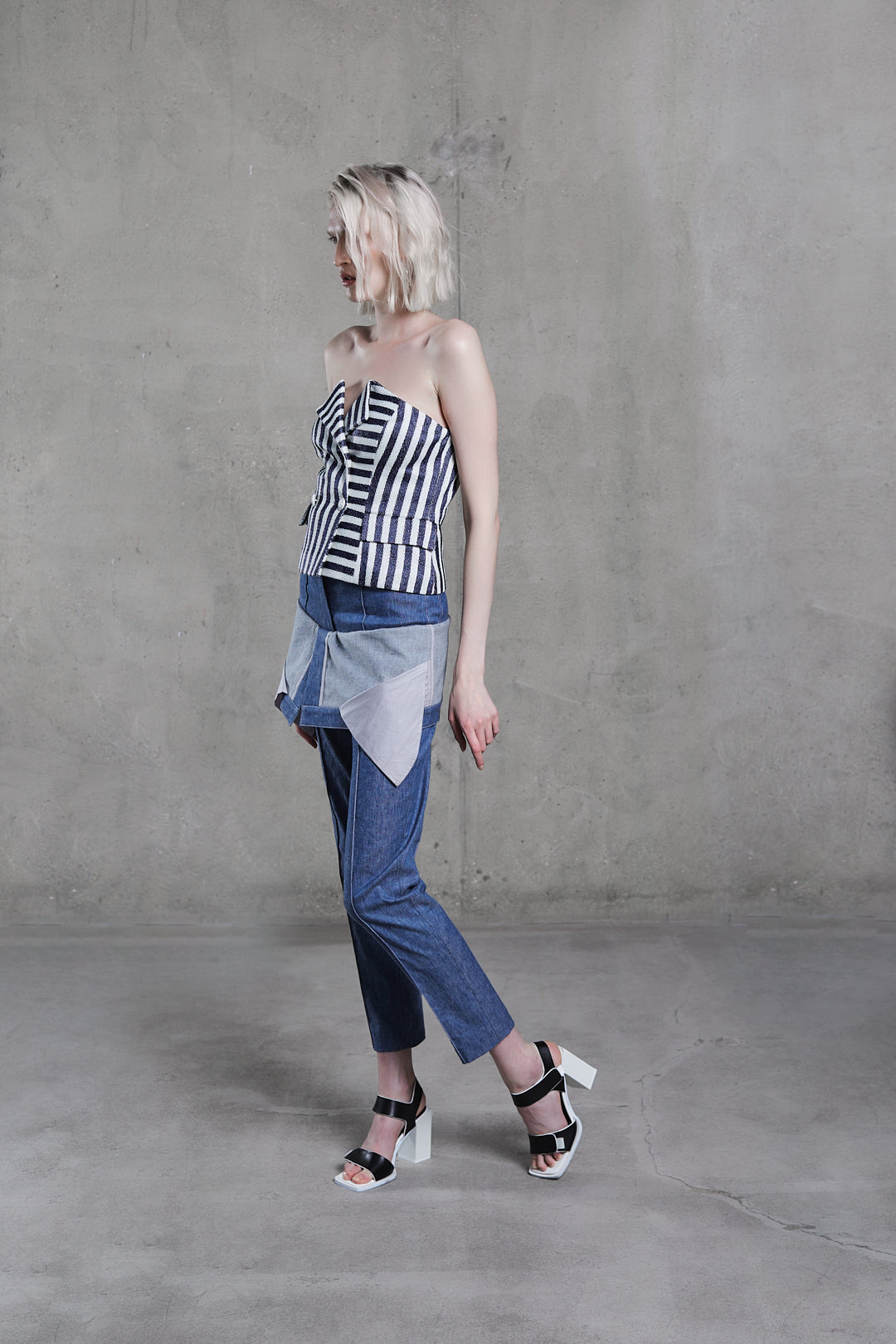 Double Breasted Stripped Raffia Corset styled with blue panel trousers, side profile studio view
