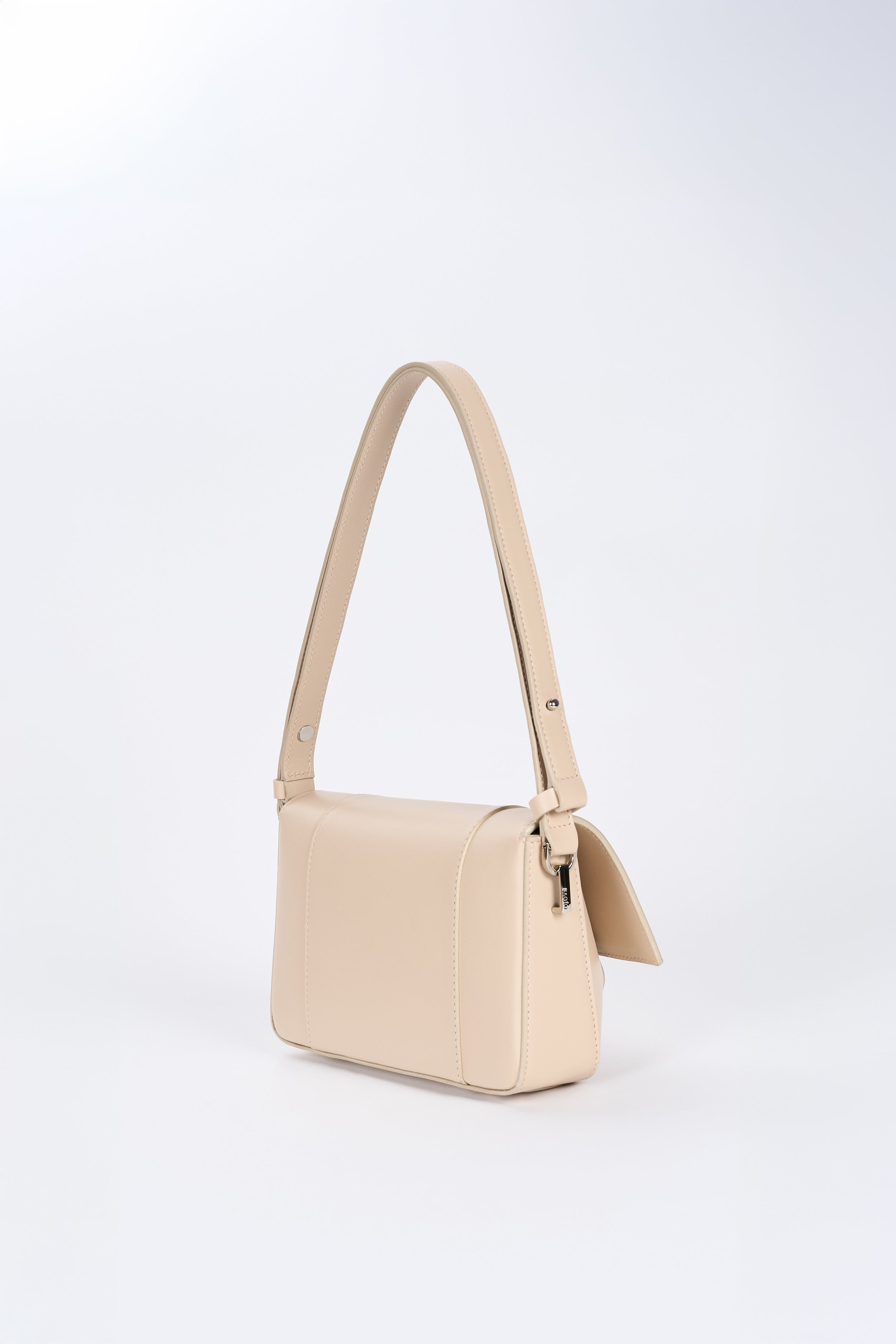 Beige leather shoulder bag side view with structured silhouette and adjustable strap