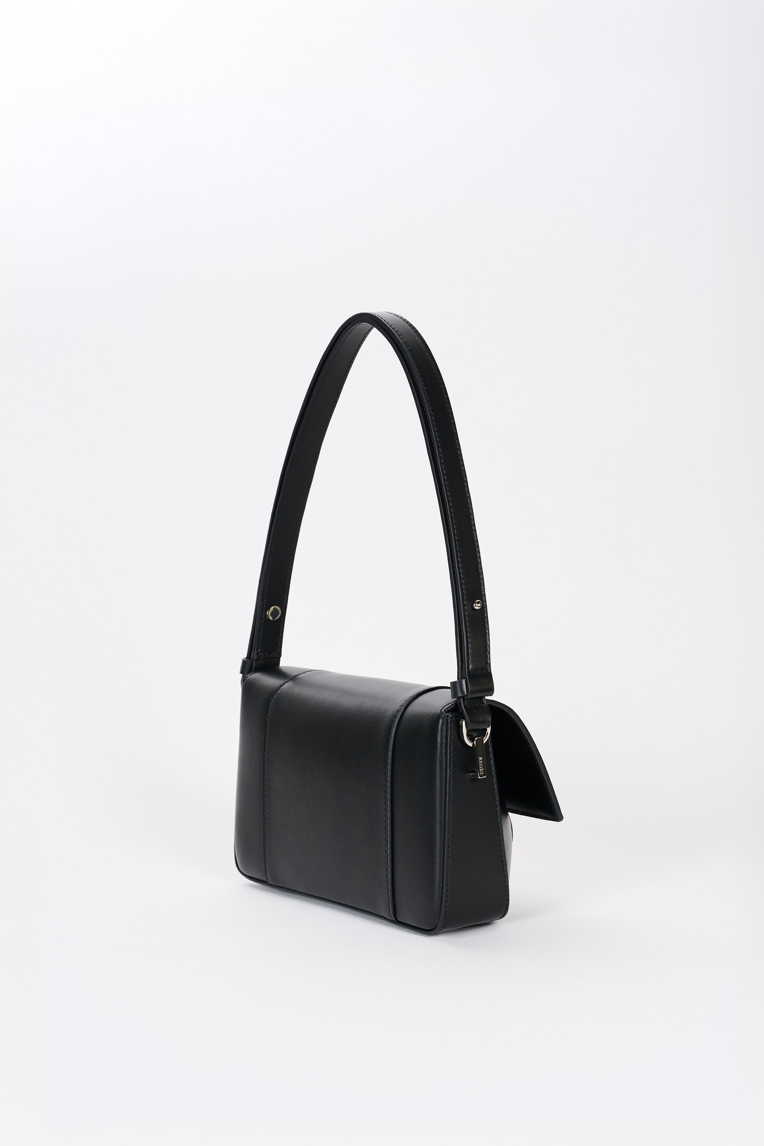 Black leather shoulder bag side view with structured silhouette and smooth lambskin finish