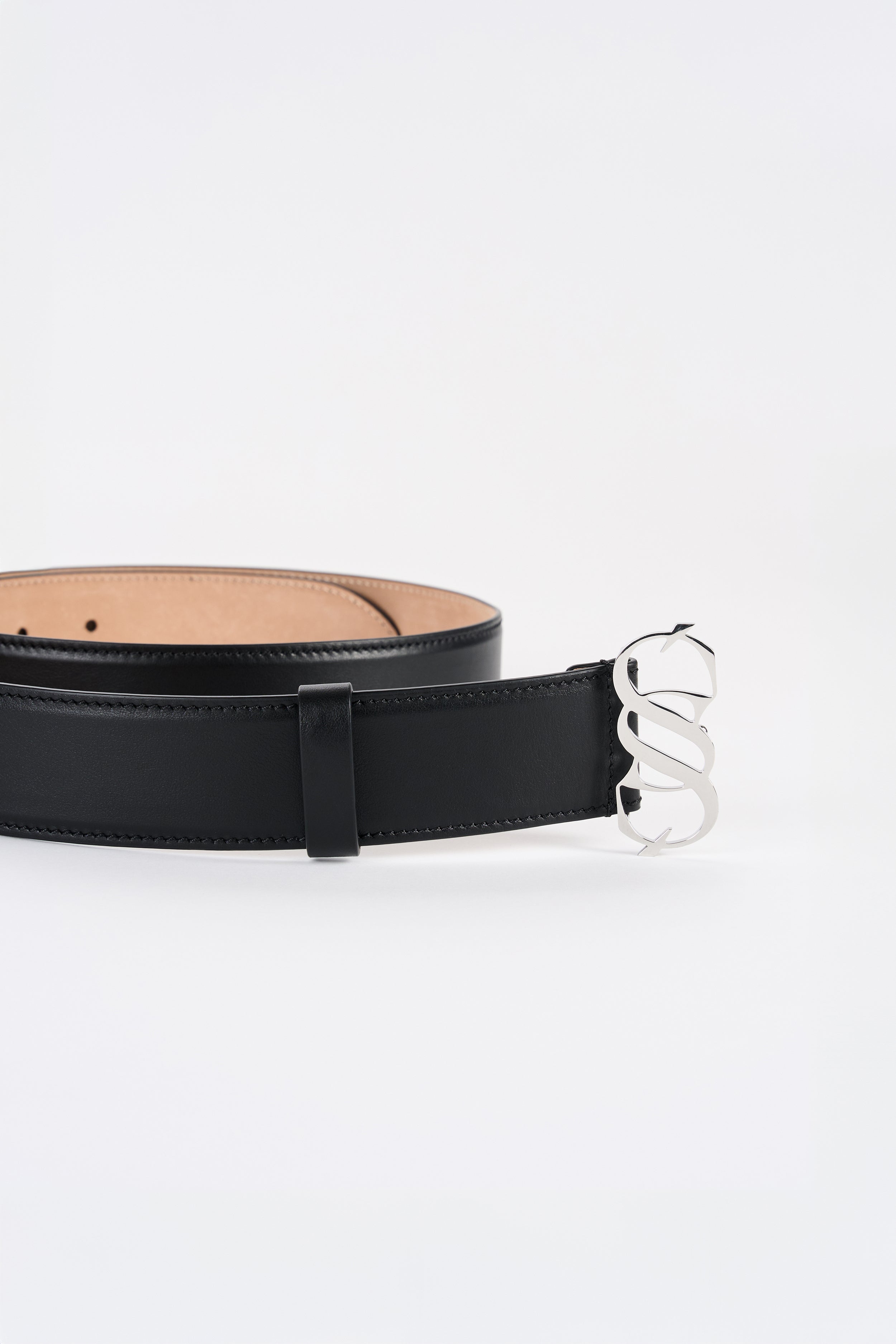 Black Italian calfskin belt with polished SAGIO monogram buckle, detail view