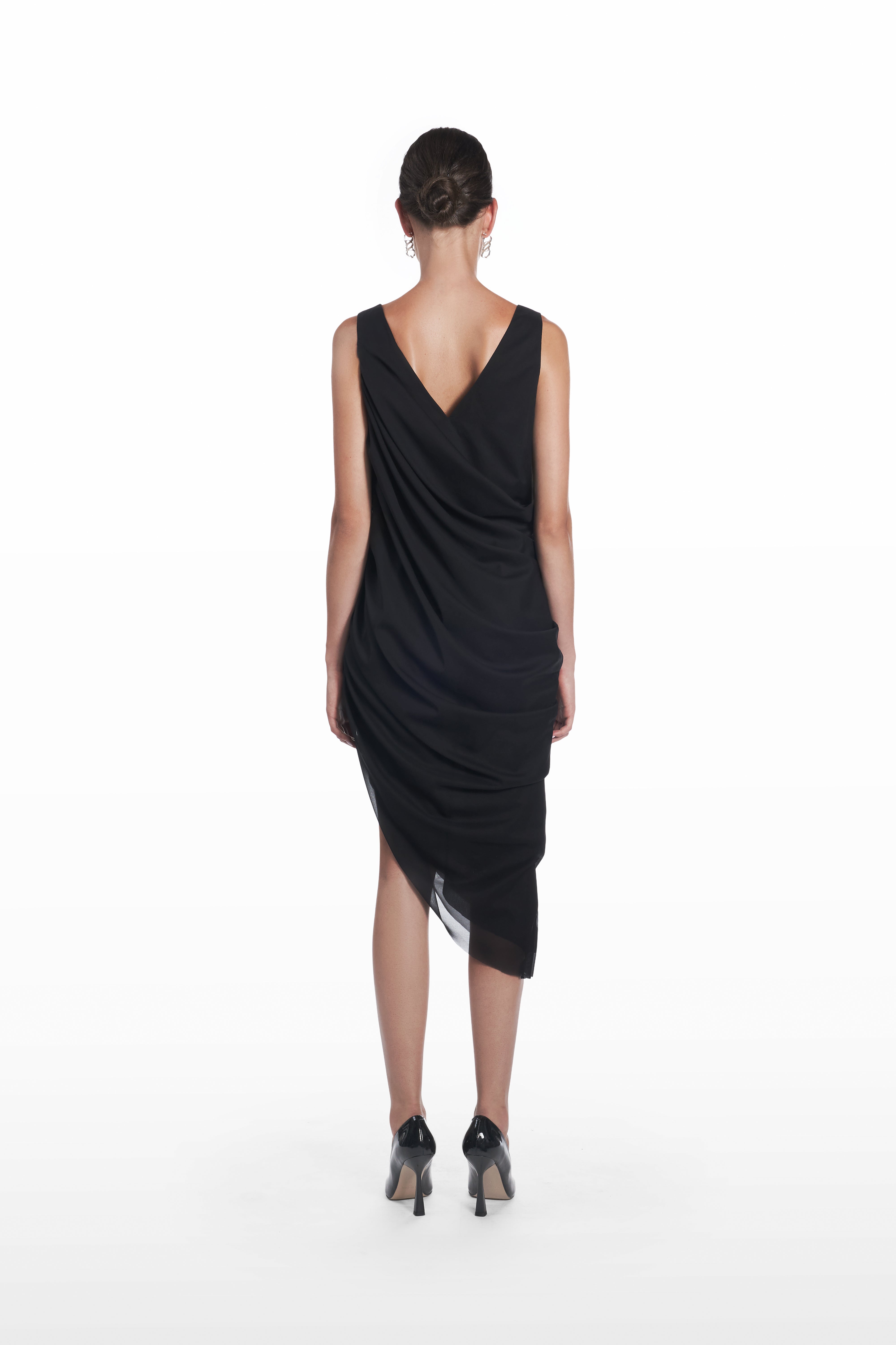 Stola Silk Dress in Black, back view, draped black silk evening dress with sleeveless cut, fluid back fold and asymmetric hemline