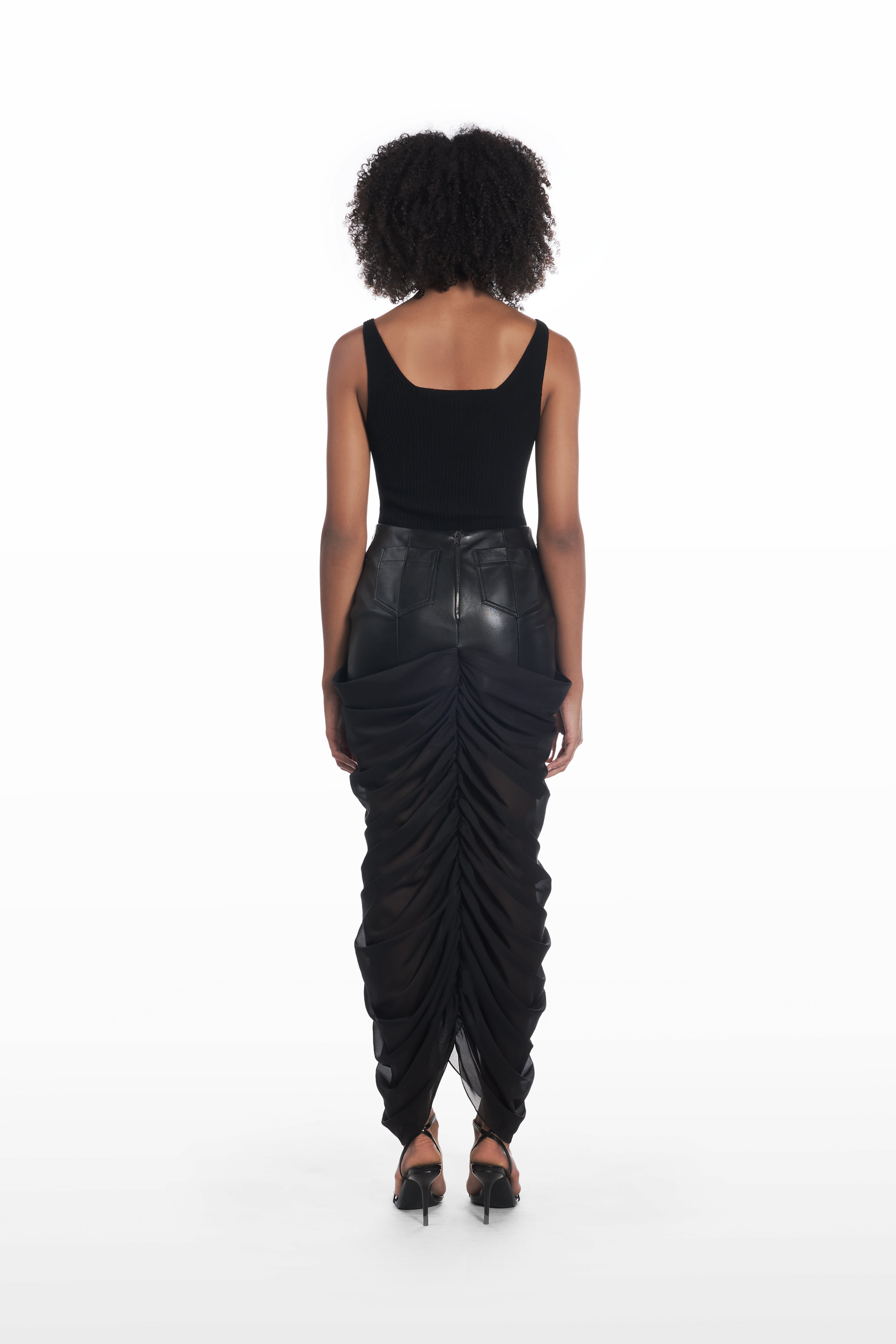Black leather and silk statement skirt back view on model