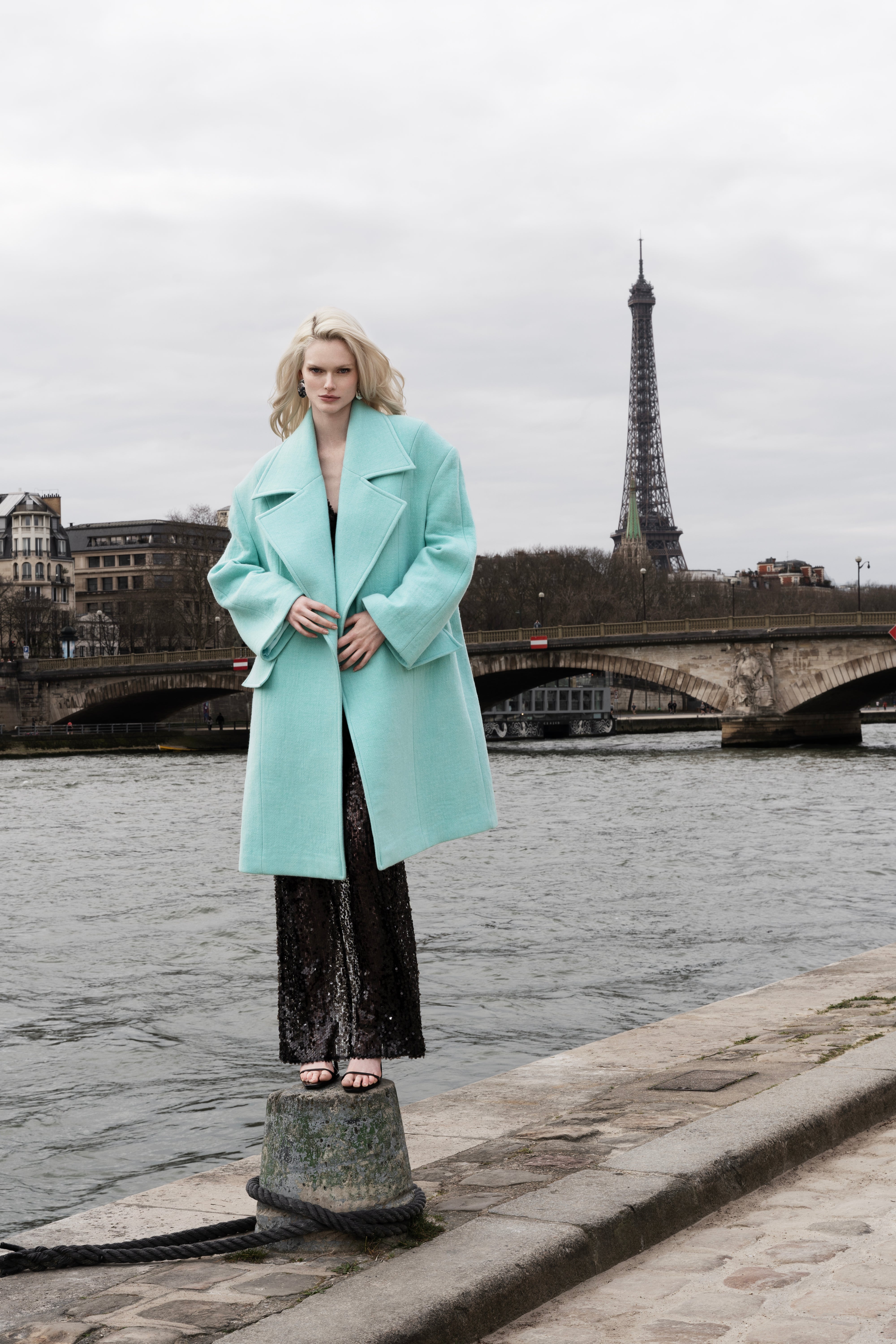 Woman in Falling Shoulder Coat, Beach Glass color; oversized wool coat with wide lapels