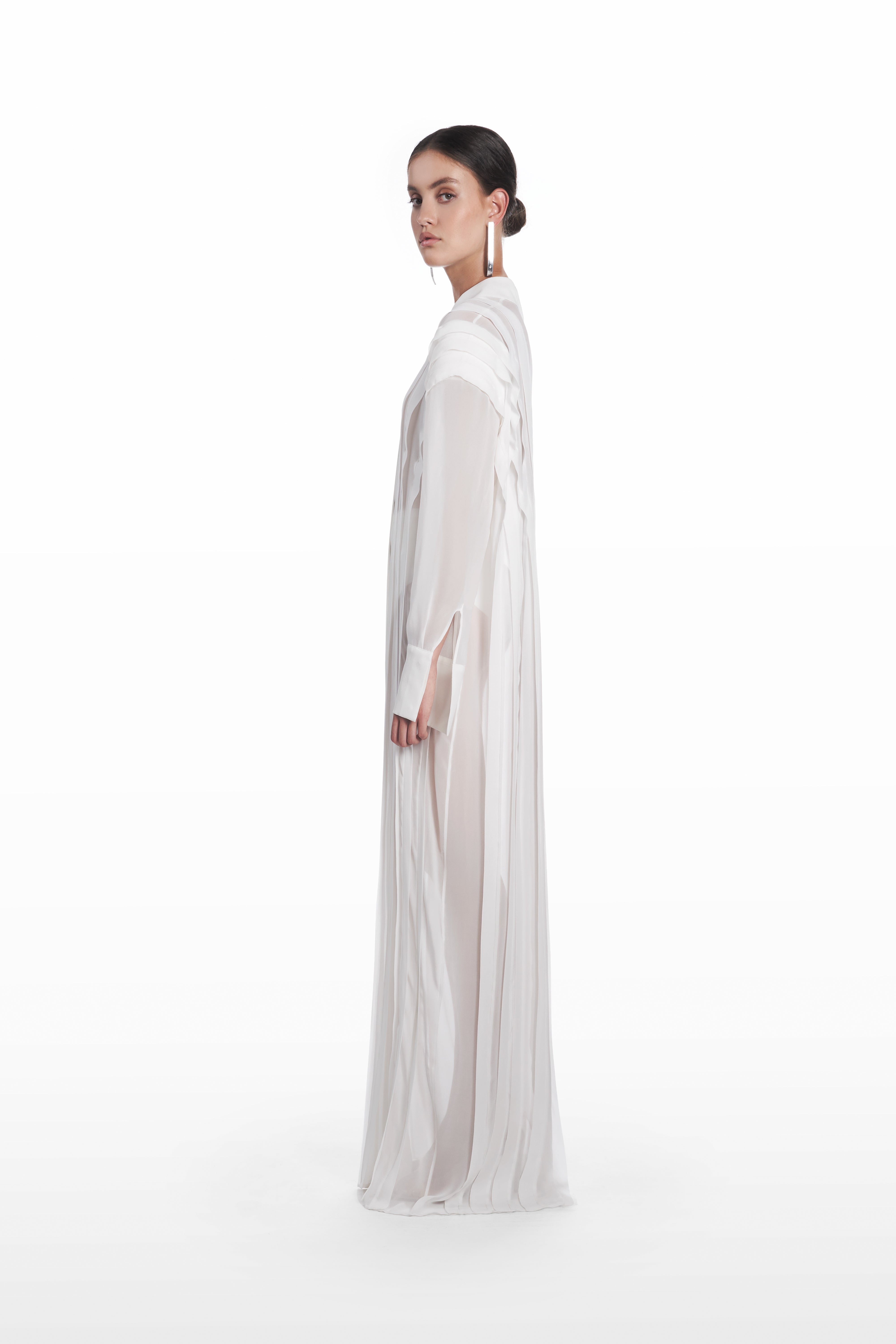 Long Transparent Plank Dress in White, side view, transparent silk evening dress with elongated drape, soft vertical paneling and cuffed sleeves