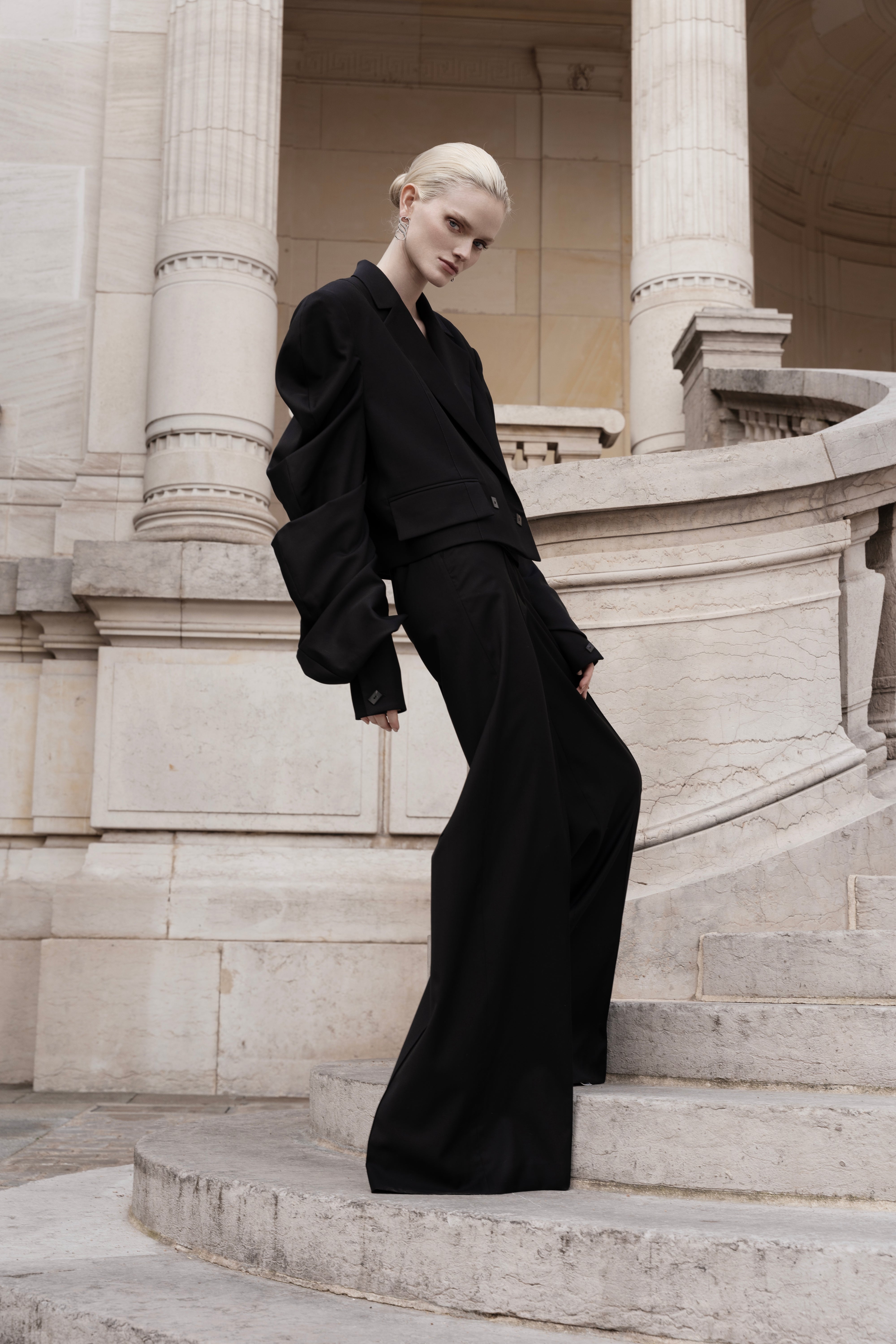 Women’s black silk trench coat with tie belt and wide lapels, longline silhouette