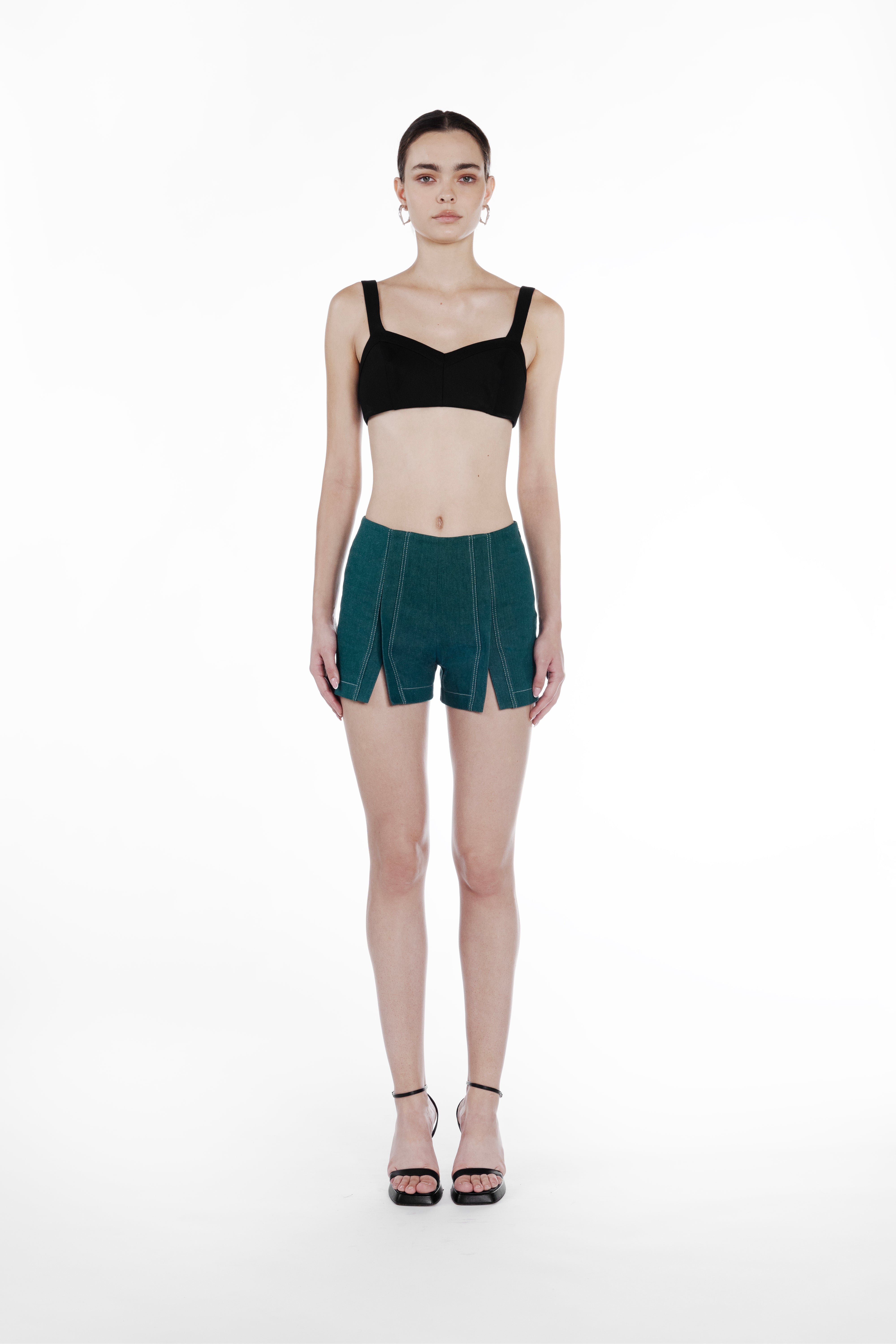 Mini Slits Shorts in Emerald Green, front view, tailored cotton mini shorts with front slit detailing, contrast topstitching and sculptural fit