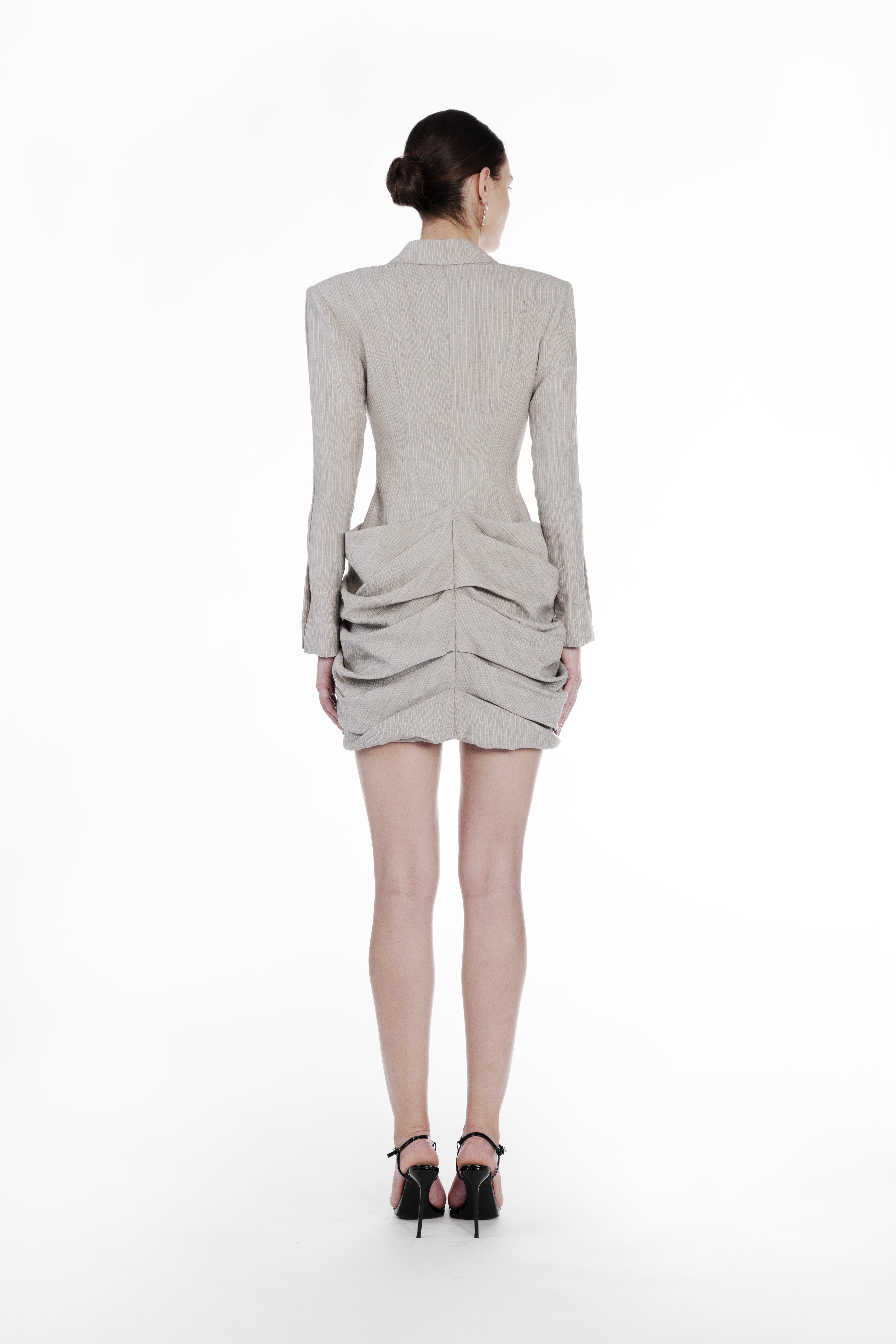 Falling Folds Stripes Dress cold beige back view with structured shoulders and layered folded mini skirt