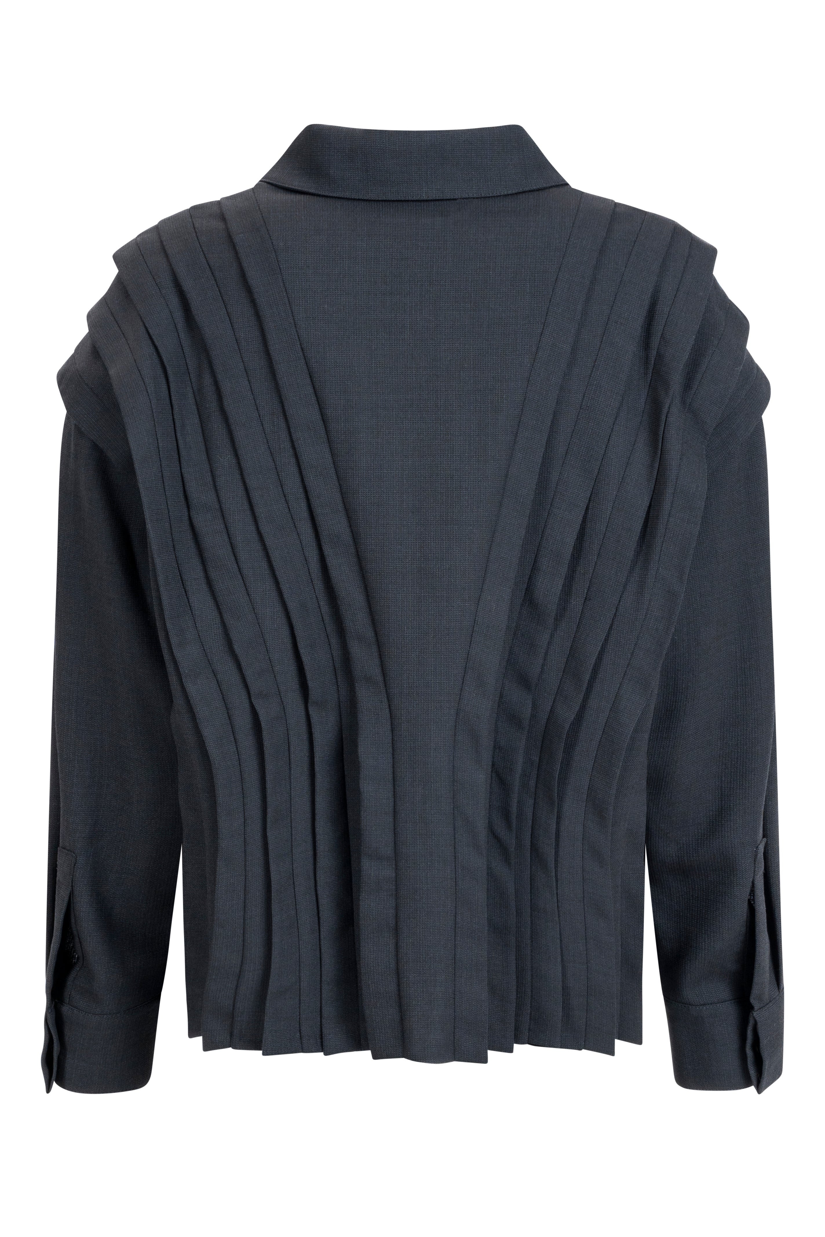 Black wool blouse showing layered pleated back panels, collar and long sleeves; structured short blouse for women.
