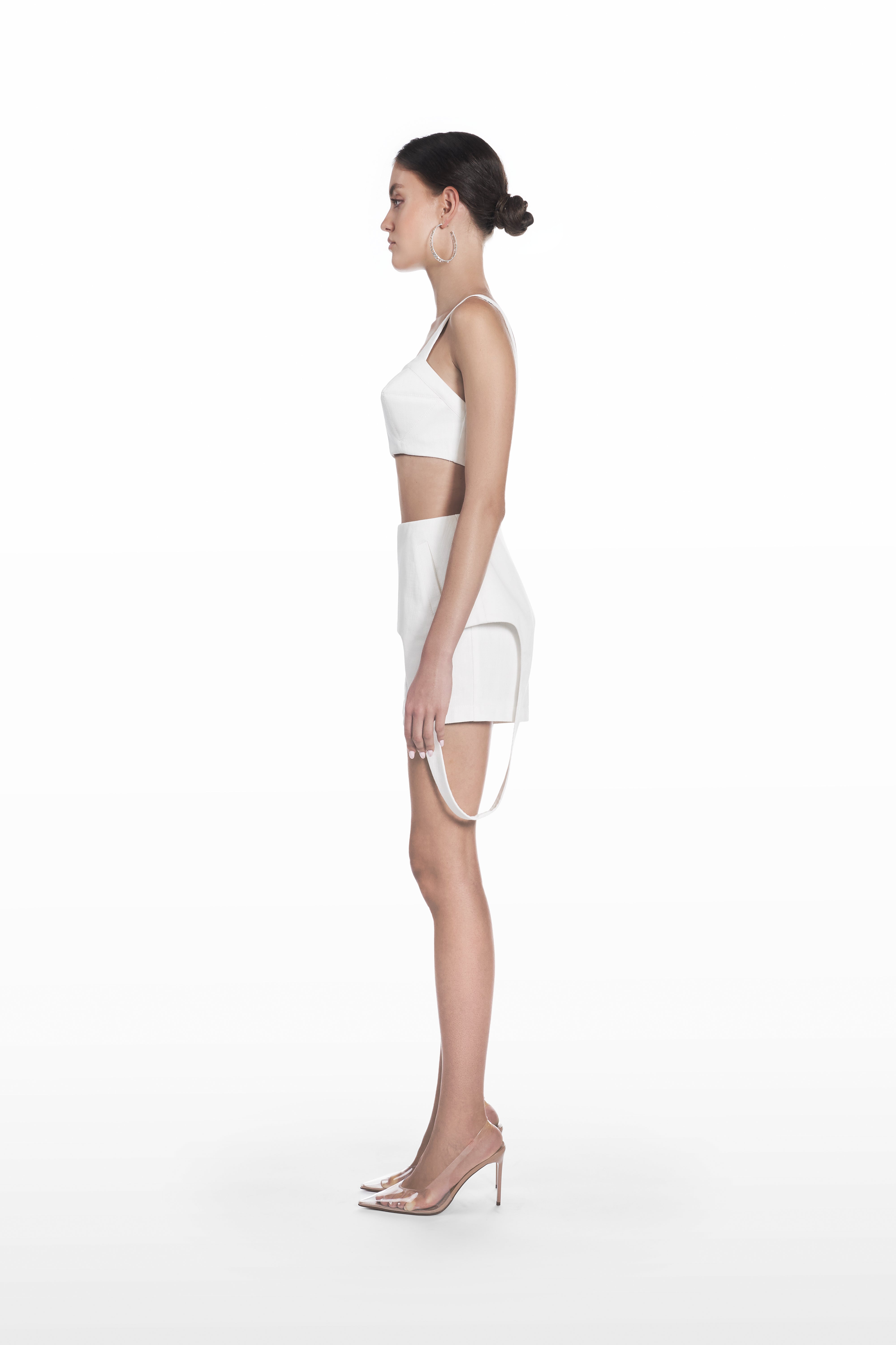 Denim falling shorts in white, side view with layered falling detail and clean fitted shape