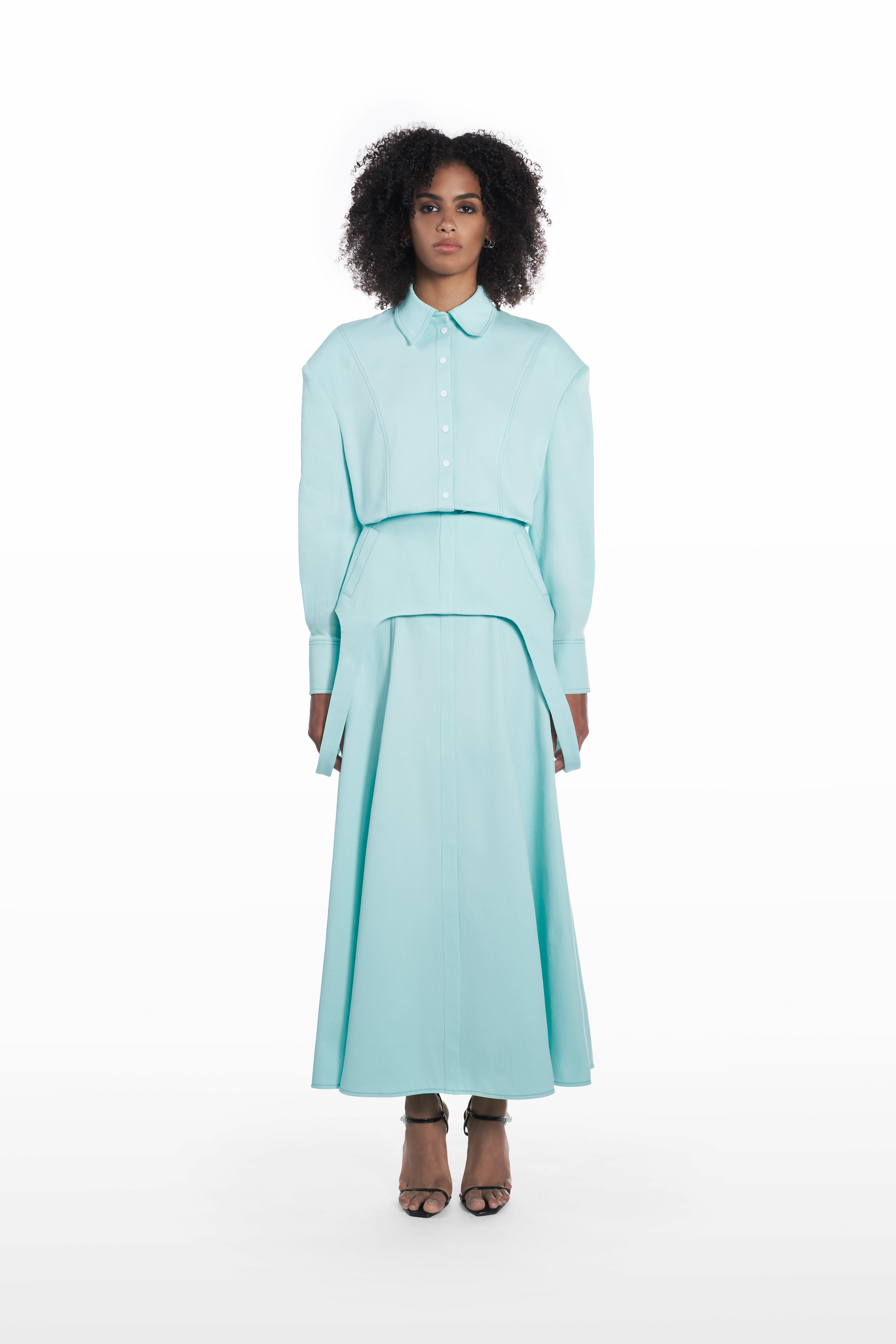 Falling maxi skirt in clear aqua, front view with sculptural drape and long flowing shape styled with a matching blouse