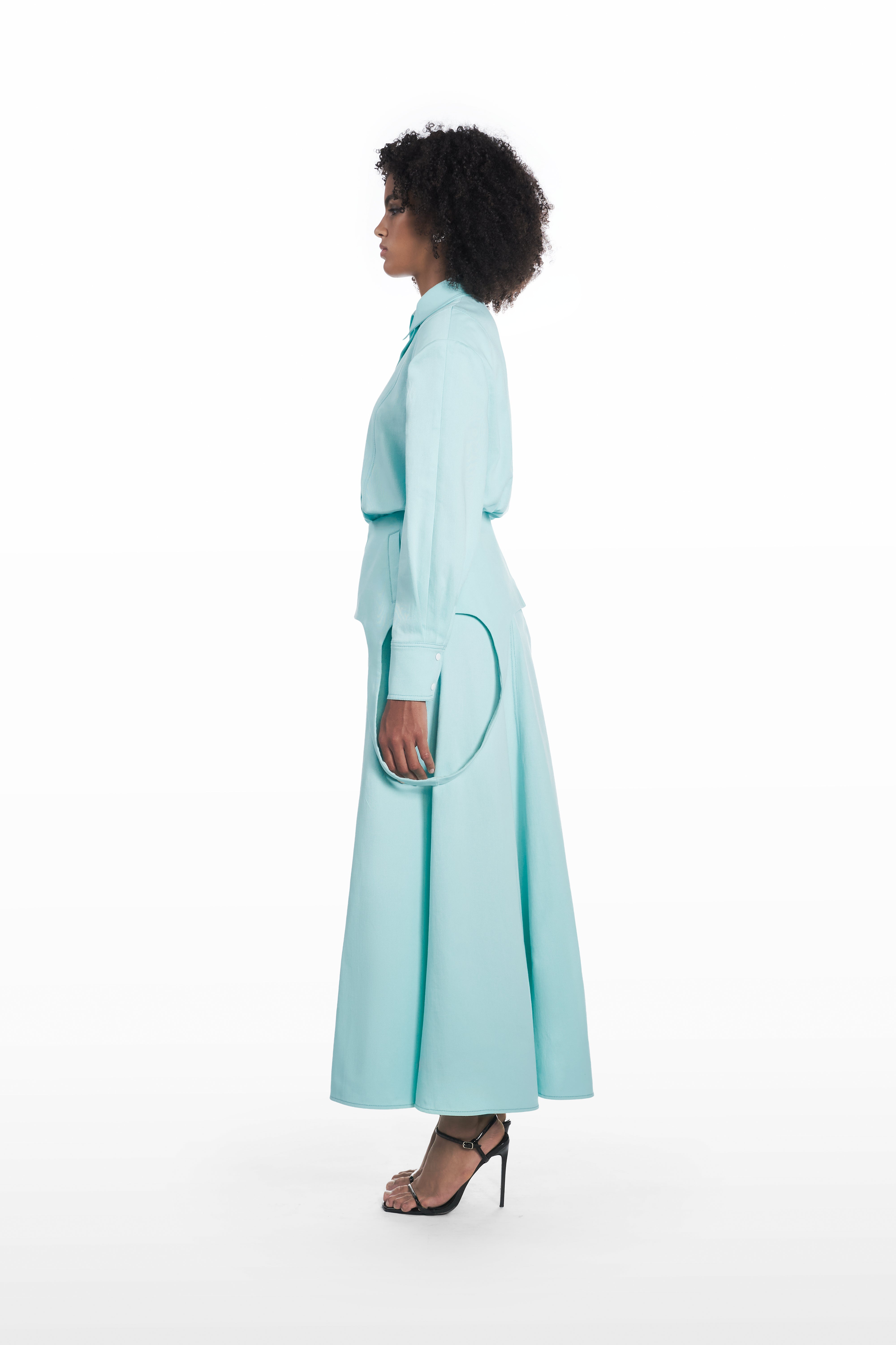 Falling maxi skirt in clear aqua, side view with fluid full-length silhouette styled with a matching blouse