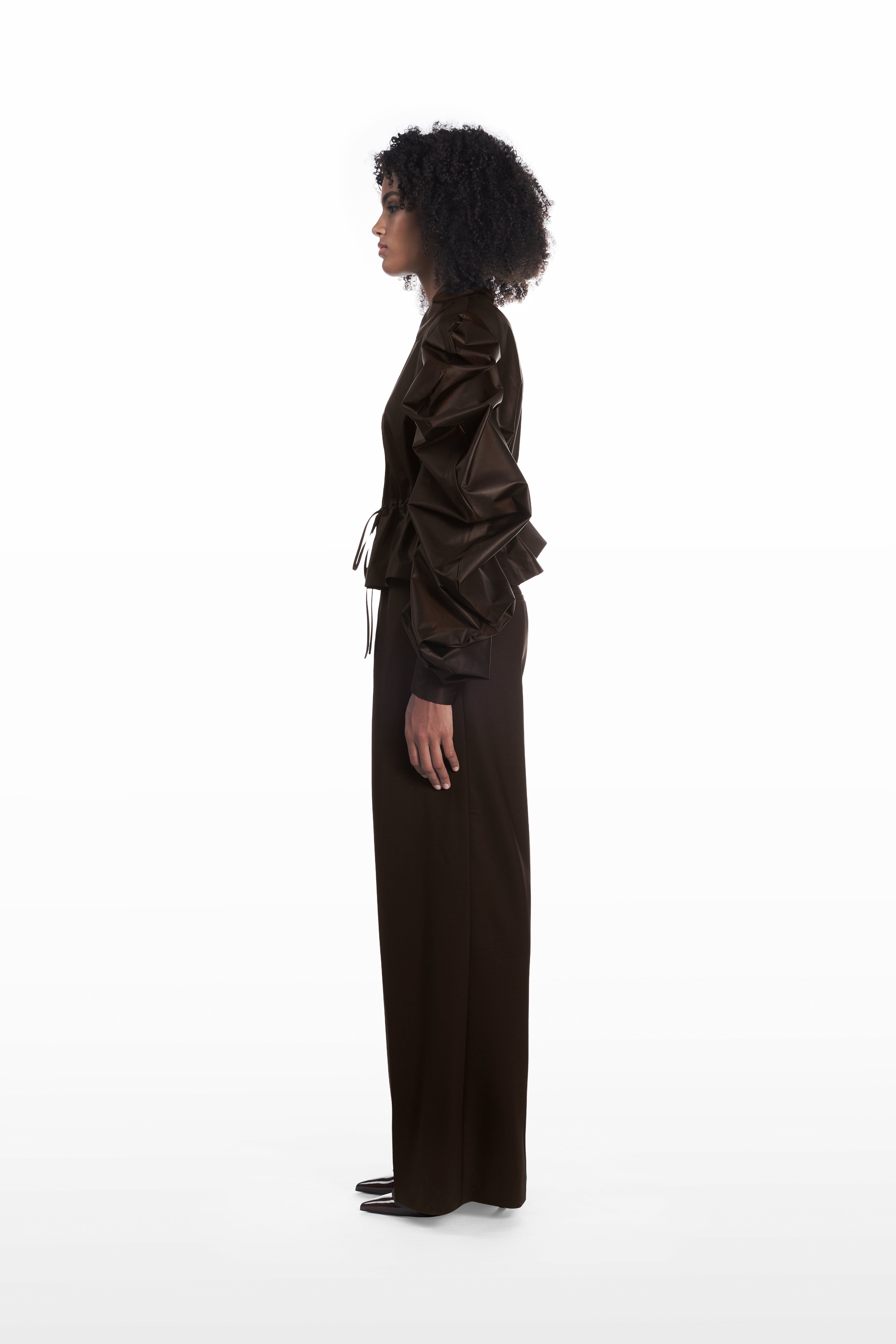 Medusa Silk Parka in dark brown, side view showing peplum shape and exaggerated sleeve construction
