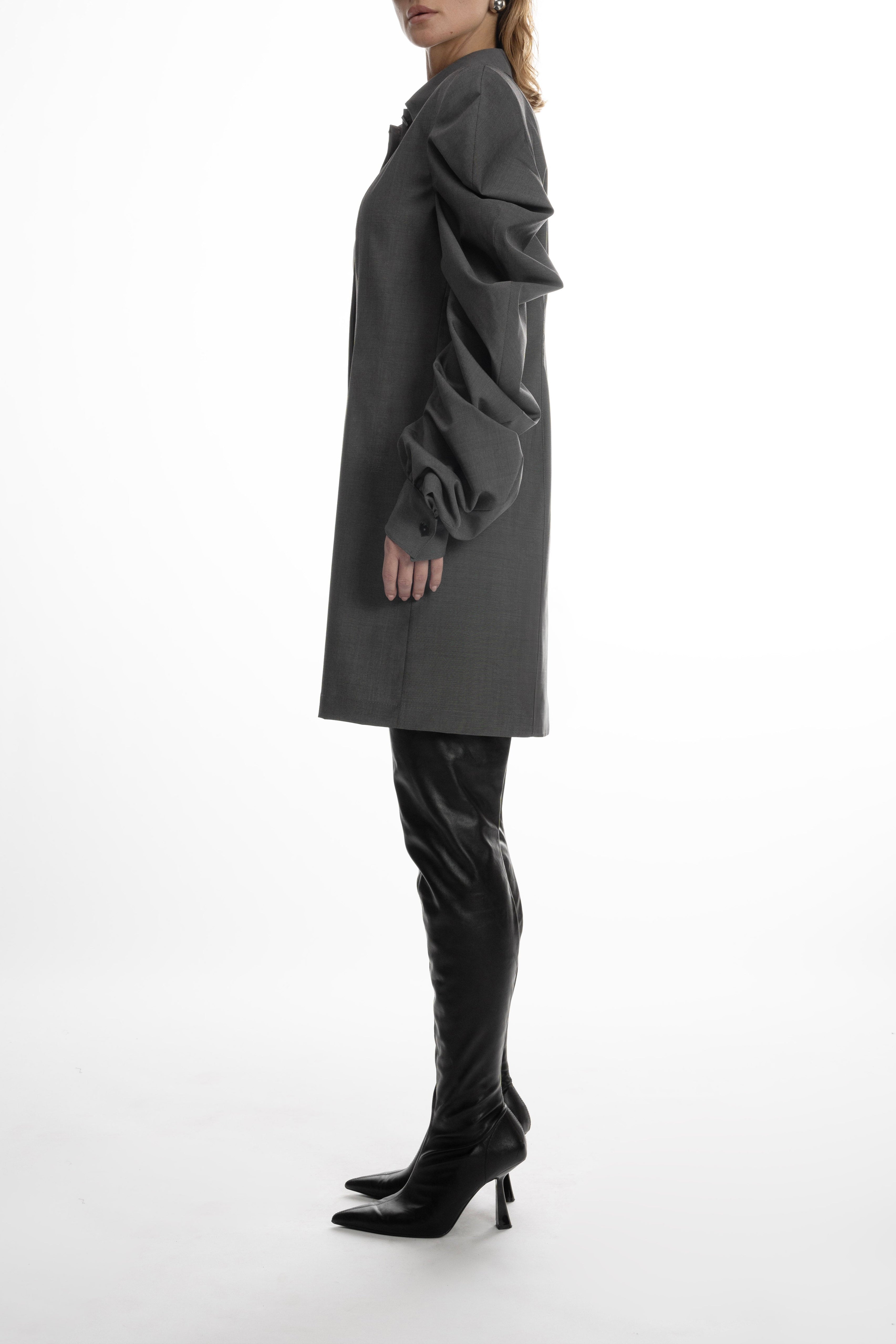Women’s wool shirt with sculptural sleeves, side view showing architectural folds