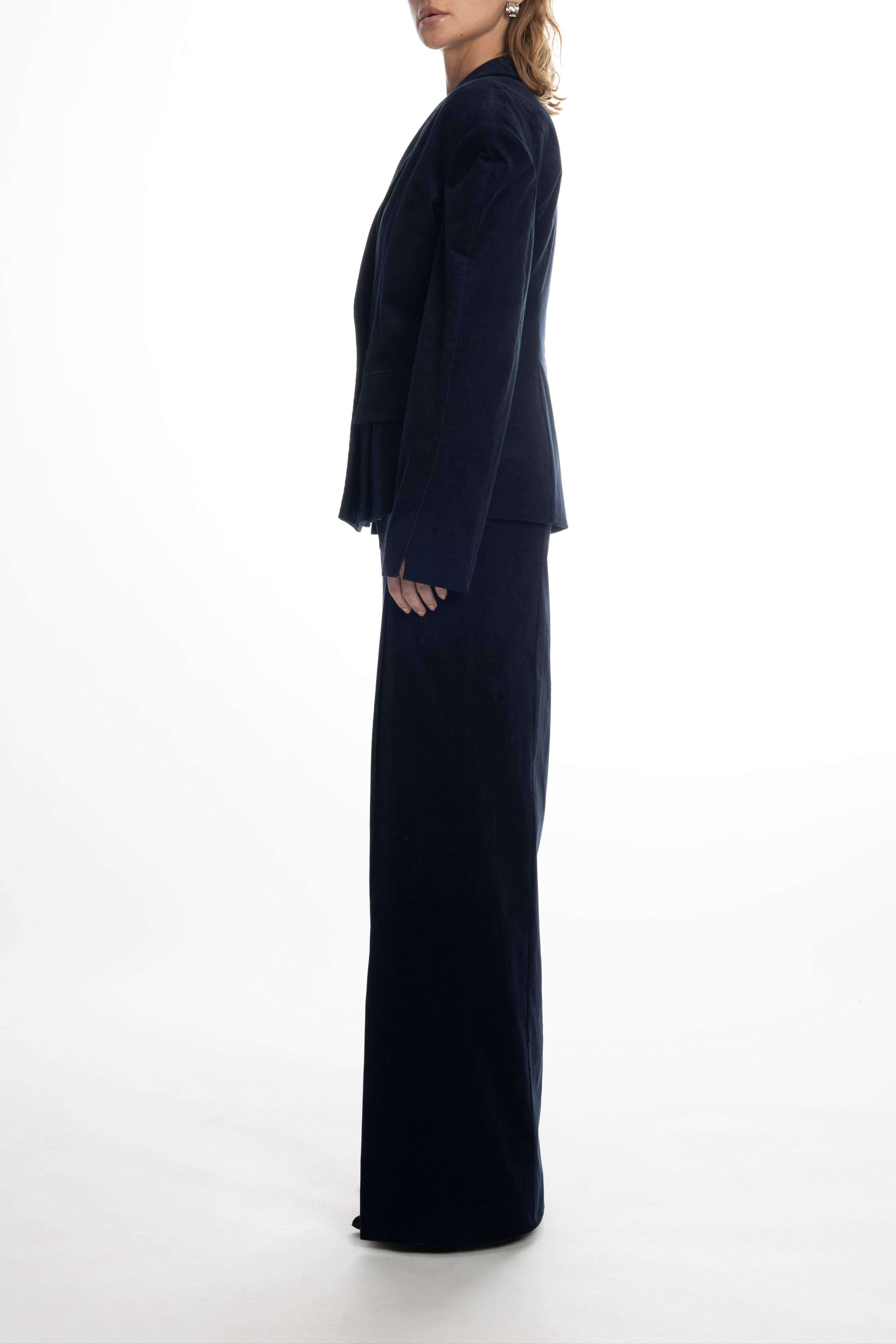 Model wearing navy long skirt with front slit and matching structured blazer, full-length look.