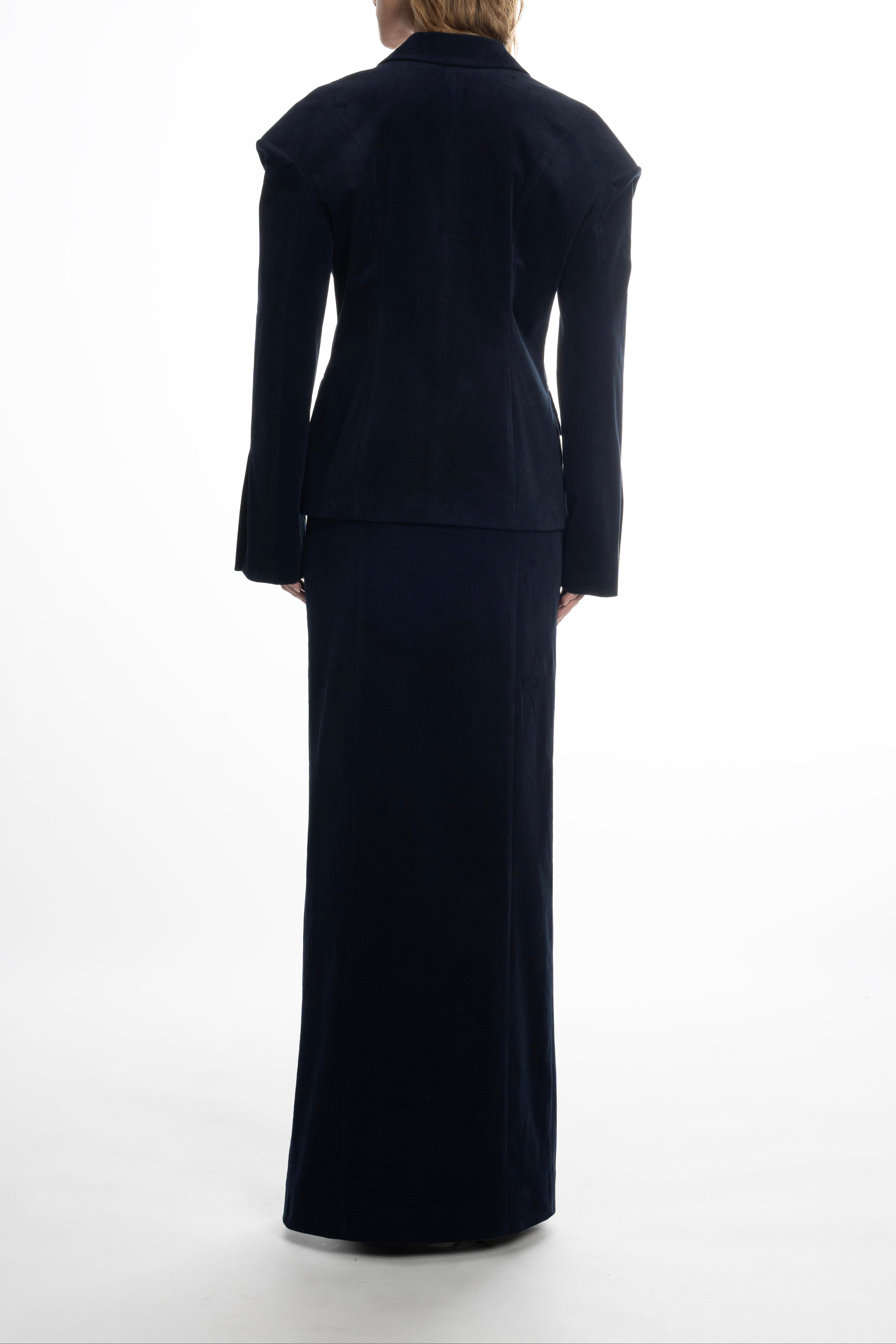 Woman wearing a navy blue suit, long cotton maxi skirt in navy with smooth seams.