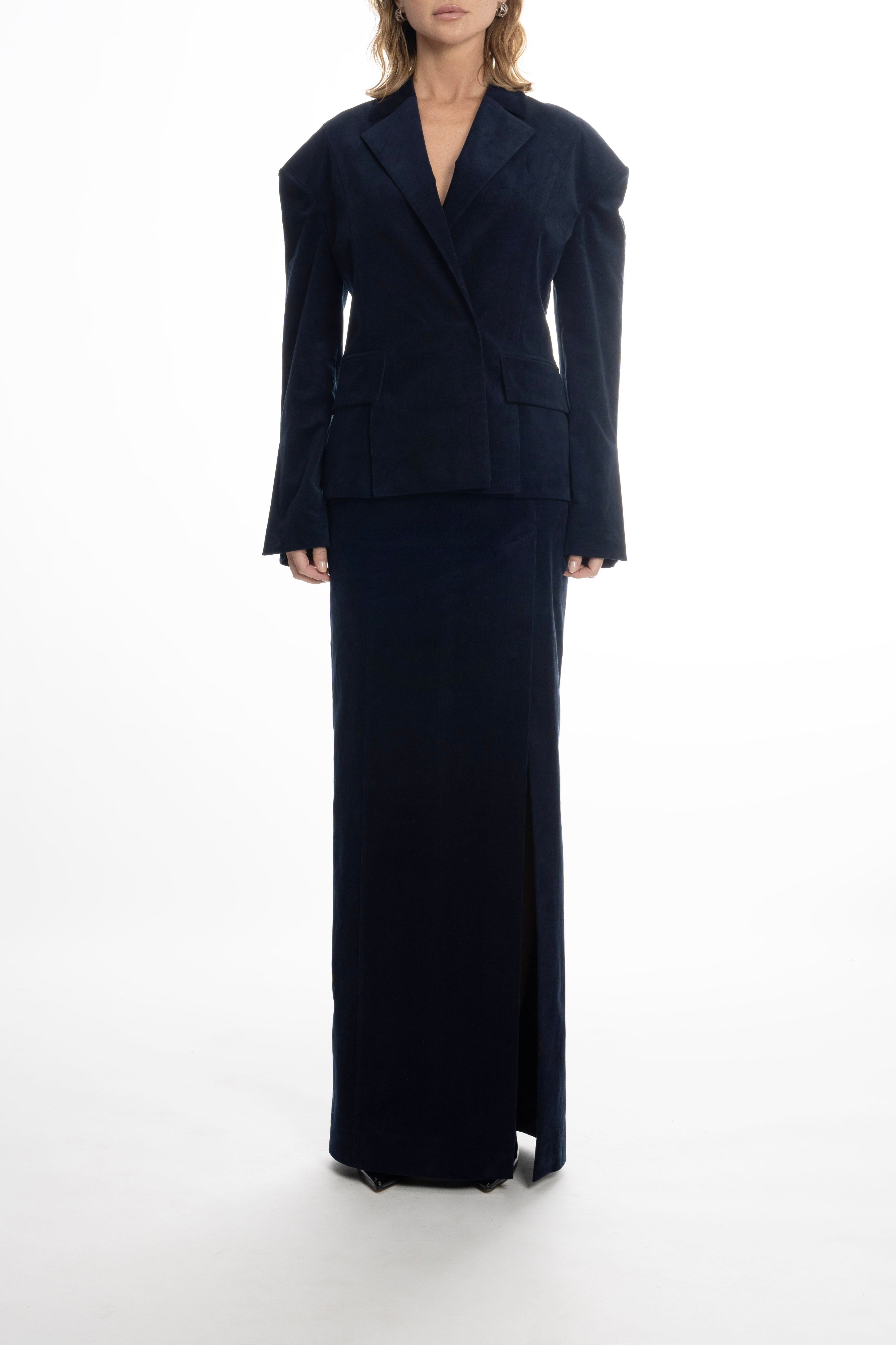 Model in navy Falling Shoulders blazer and long skirt