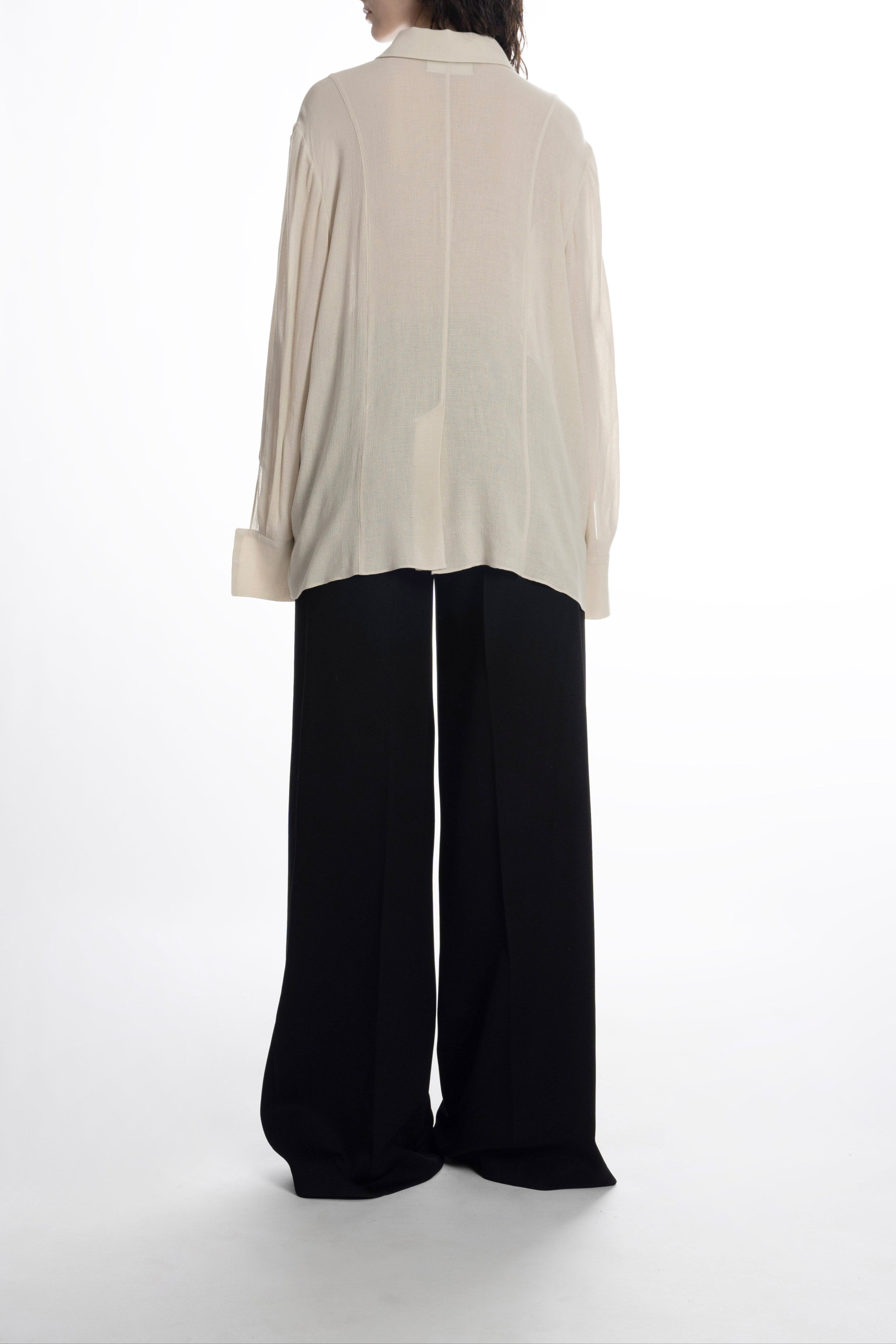 Ivory blouse on model showing airy texture and easy silhouette.