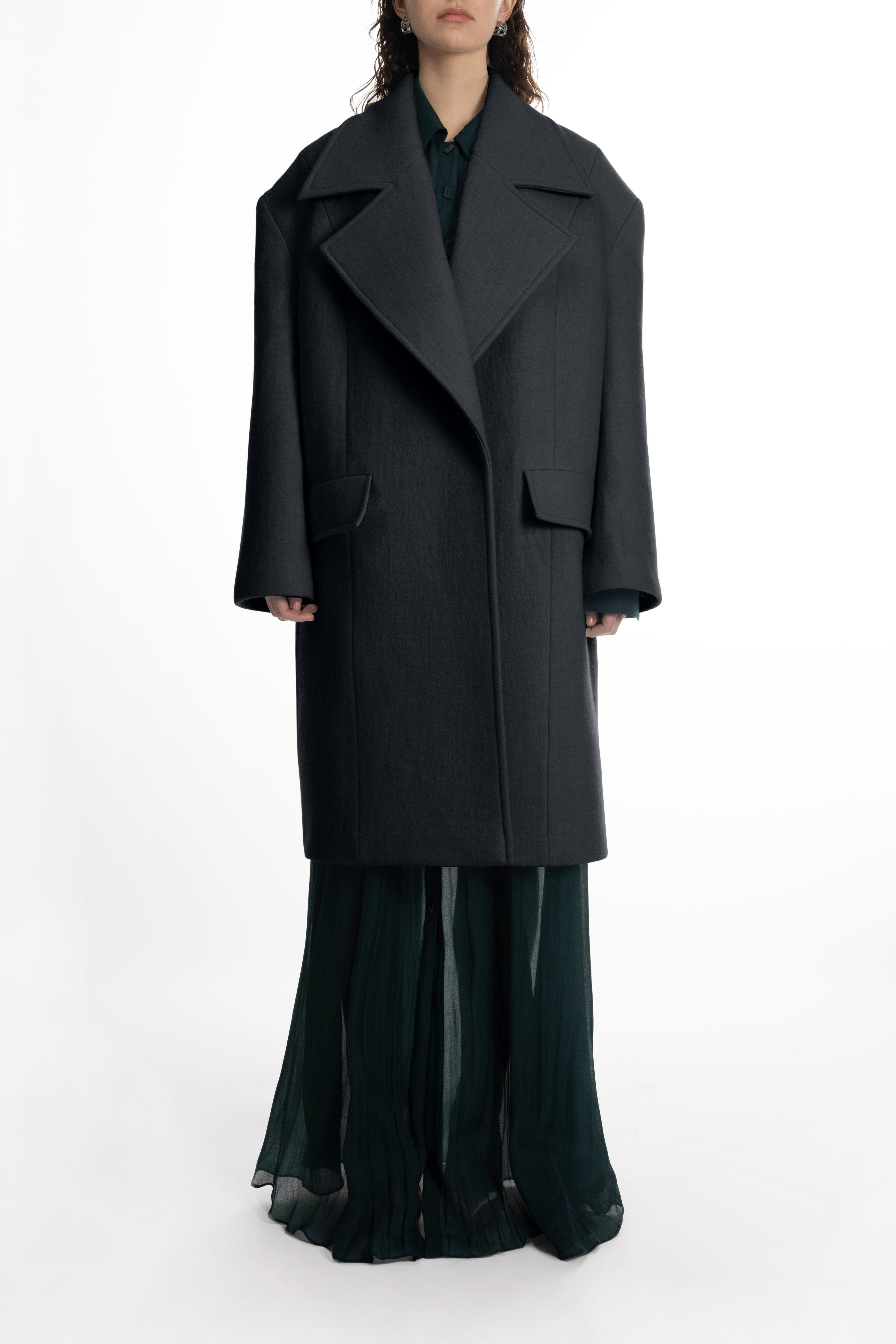 Fashion Woman's Falling Shoulder Coat in black; oversized wool design with sculptural wide lapels