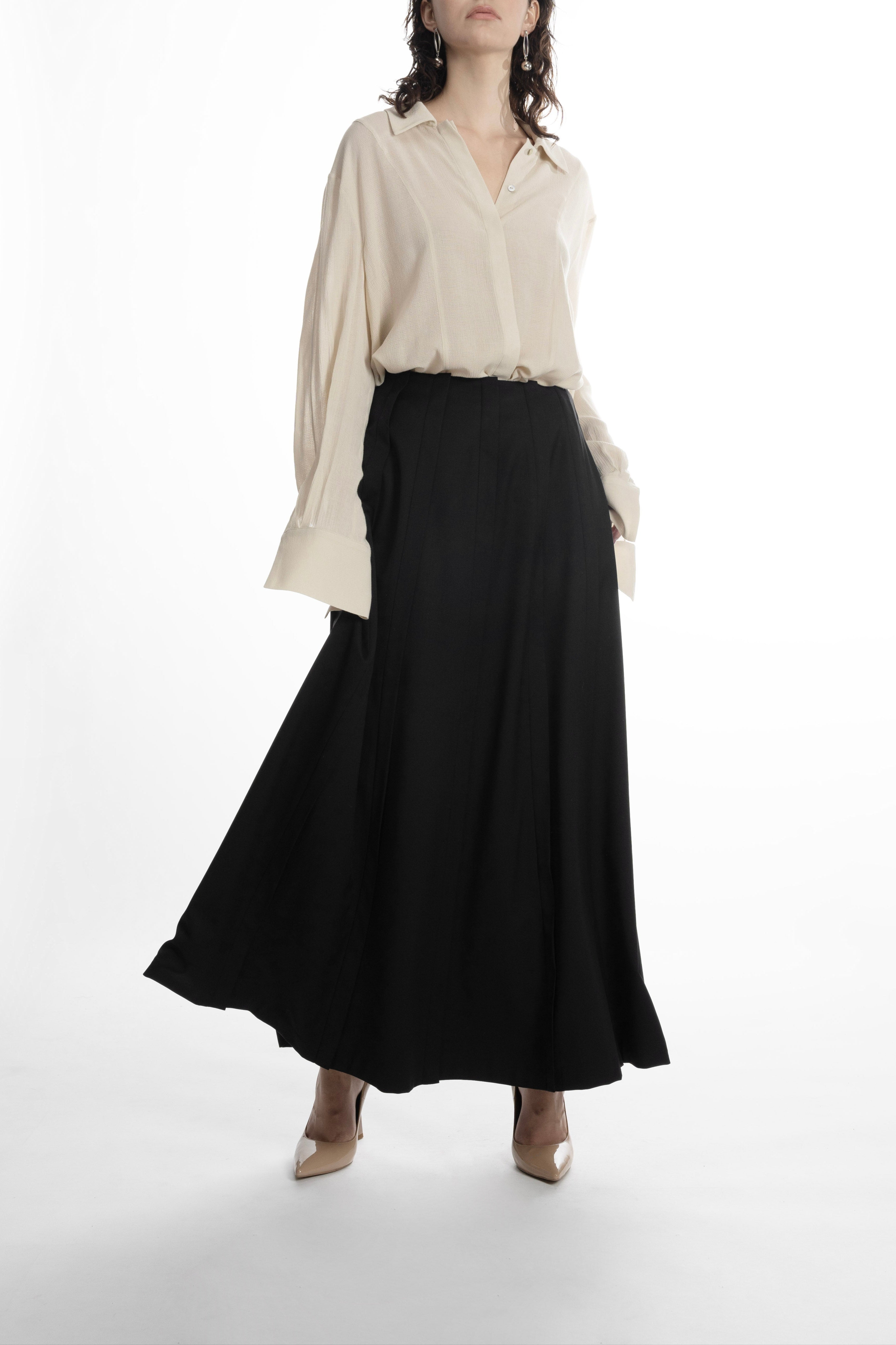 Women’s black wool maxi skirt, flowing movement, architectural pleats