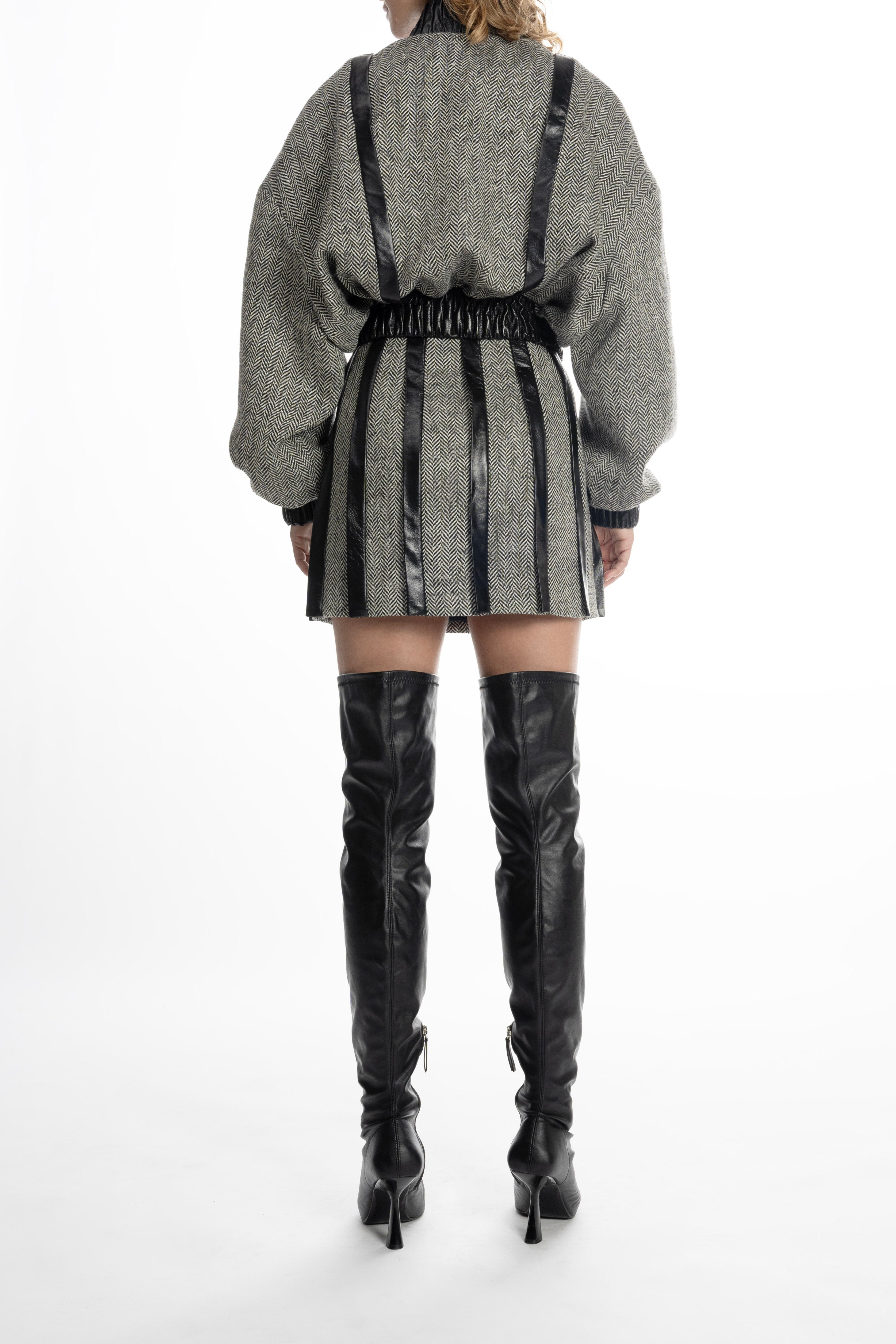 Women’s grey tweed mini skirt with leather placket stripes, back view on model