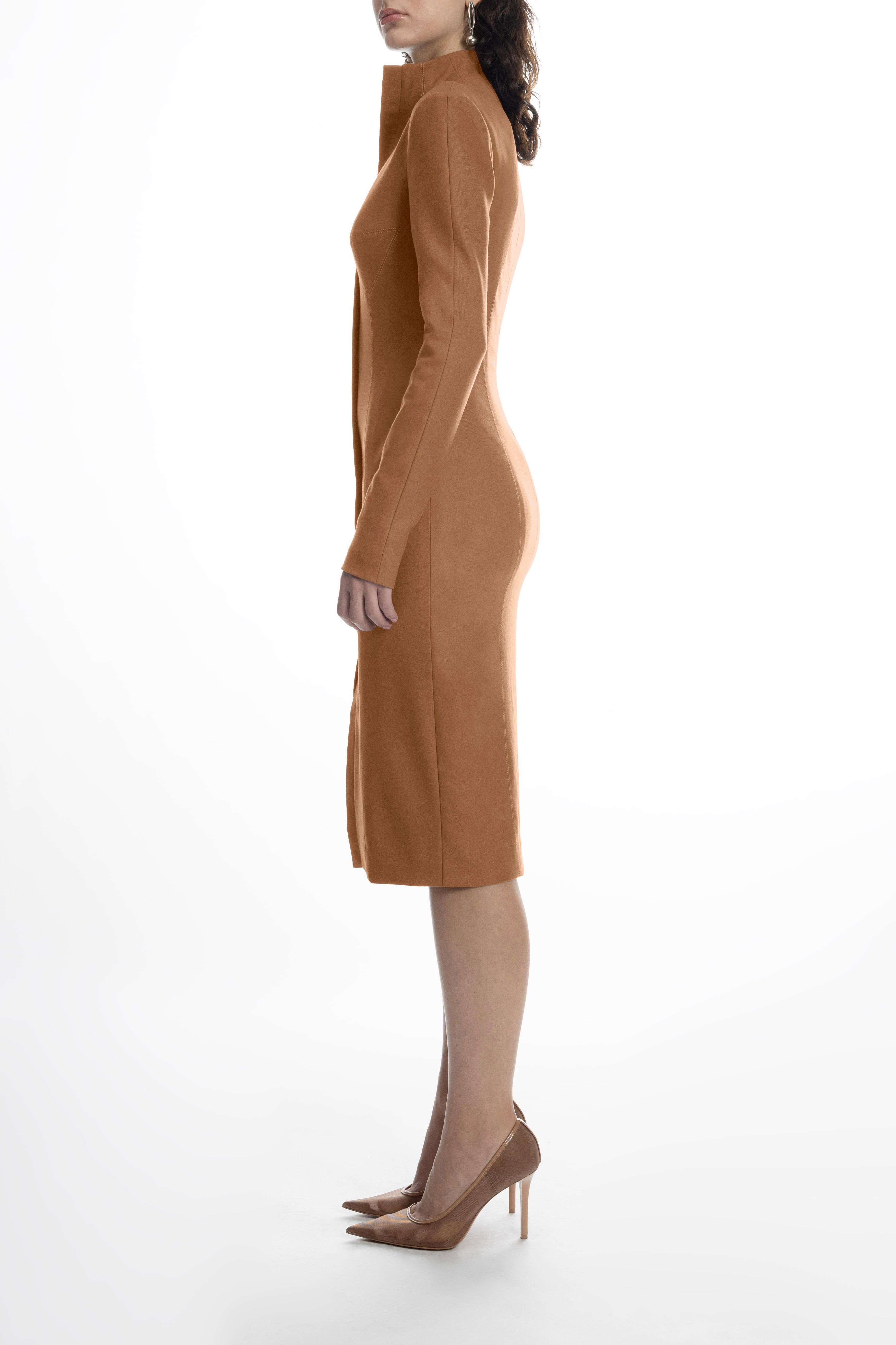 Side view showing the fitted silhouette and front vent of the light brown wool midi bustier dress with long sleeves and stand collar.