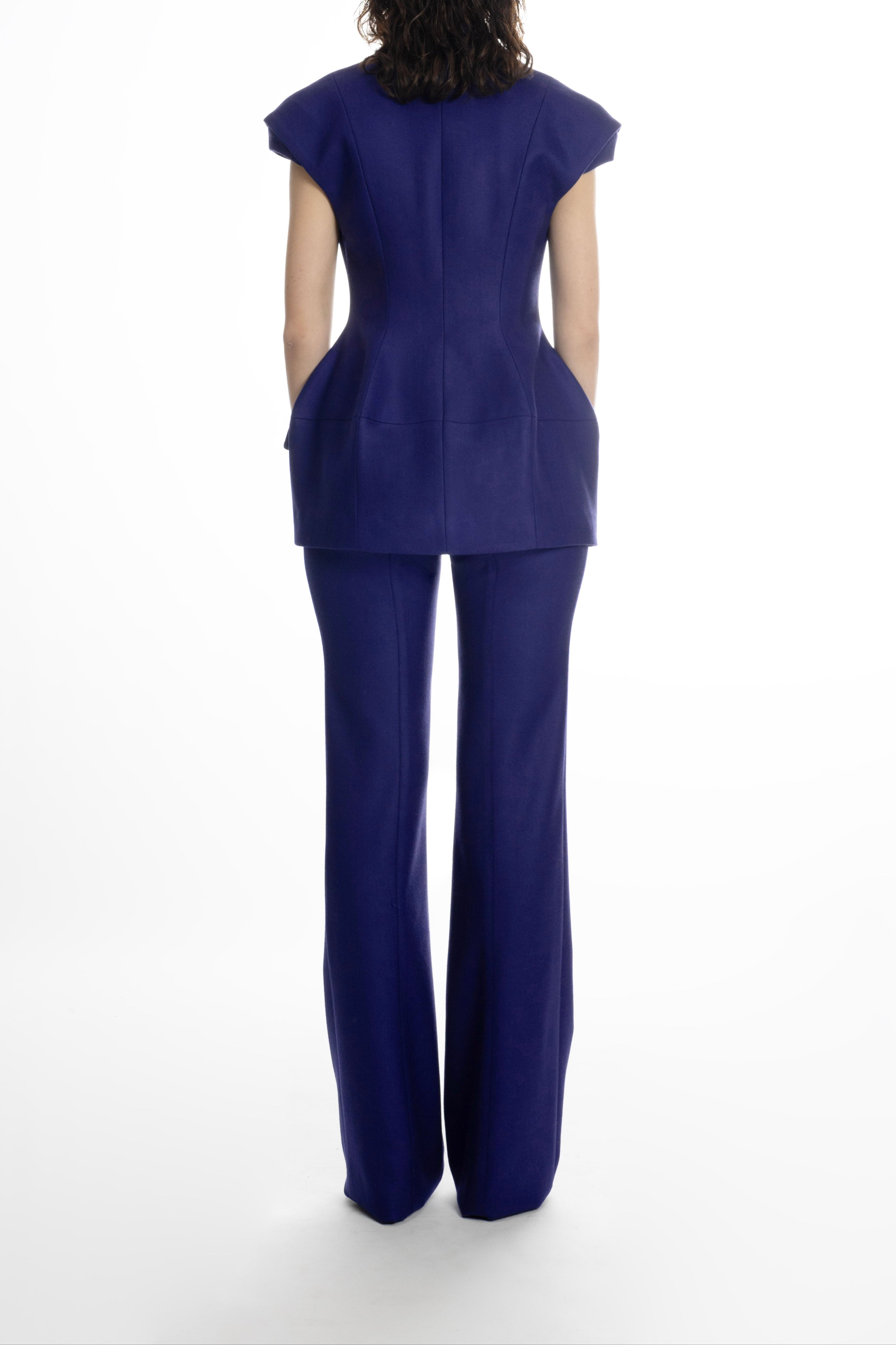 Women’s deep blue hip-length blazer, back view showing sculpted waist and clean seams