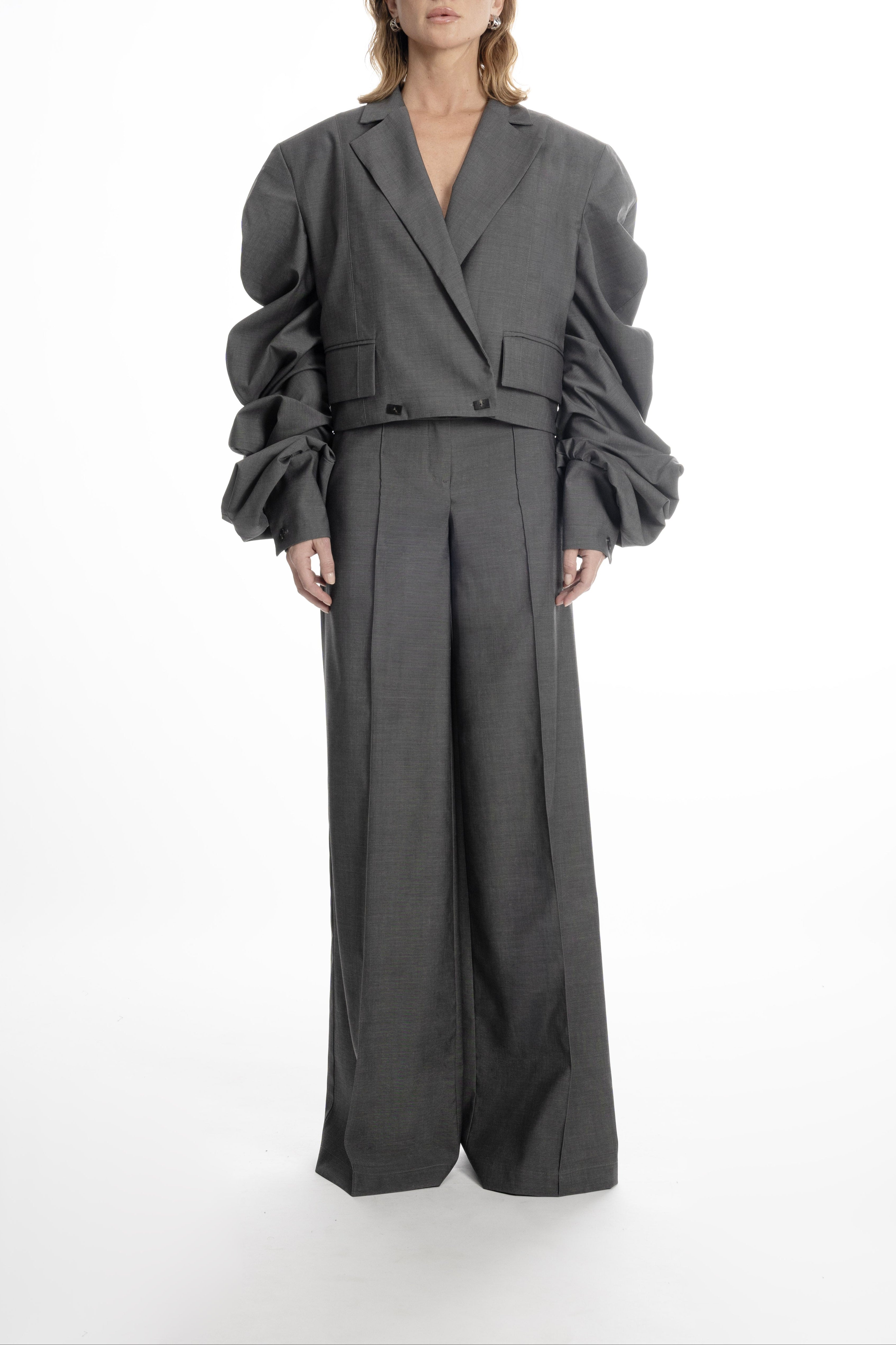 Women’s gray cropped blazer with ruched sleeves, styled with matching wide-leg trousers