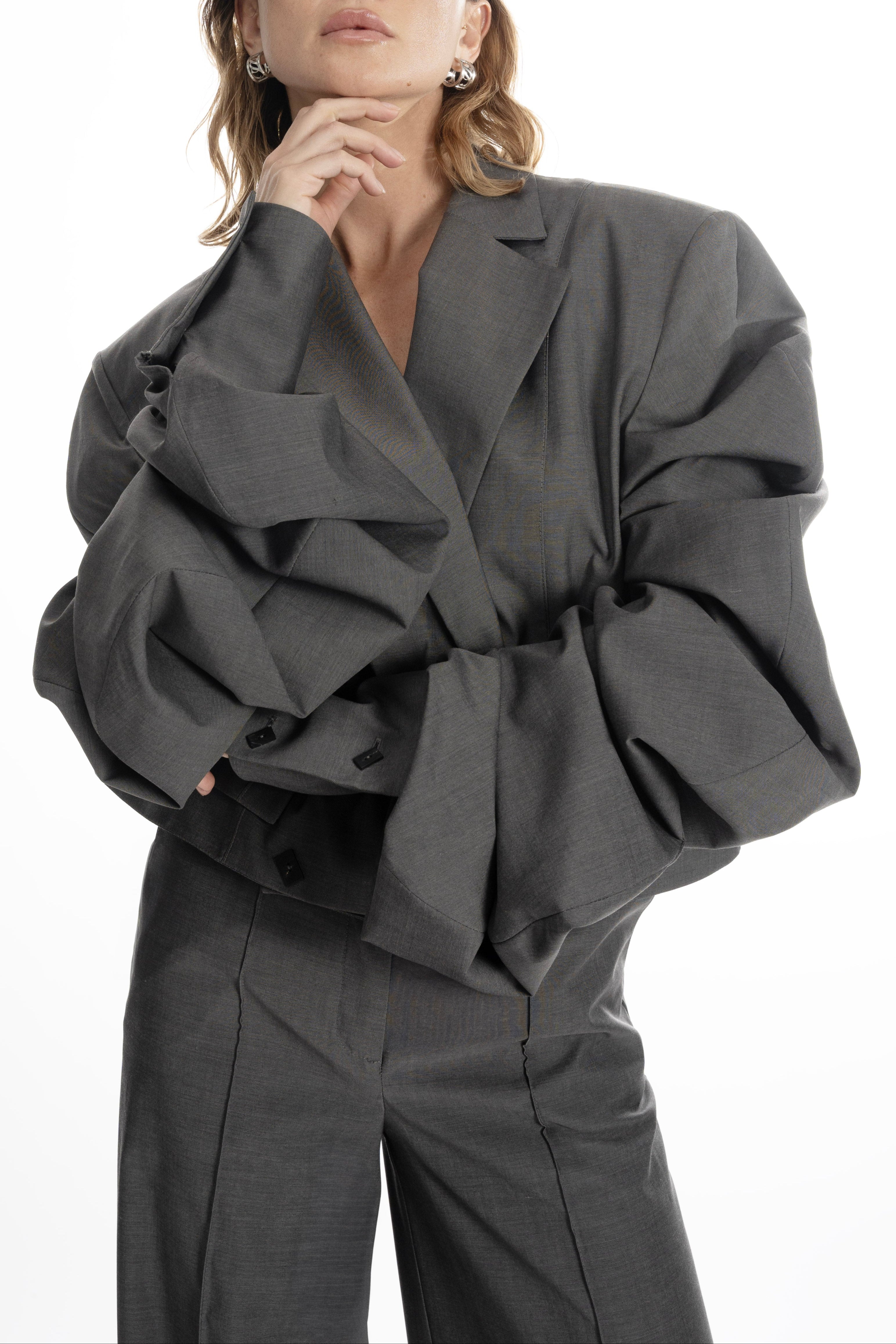 Women’s gray cropped blazer, close-up highlighting ruched statement sleeves and tailored texture