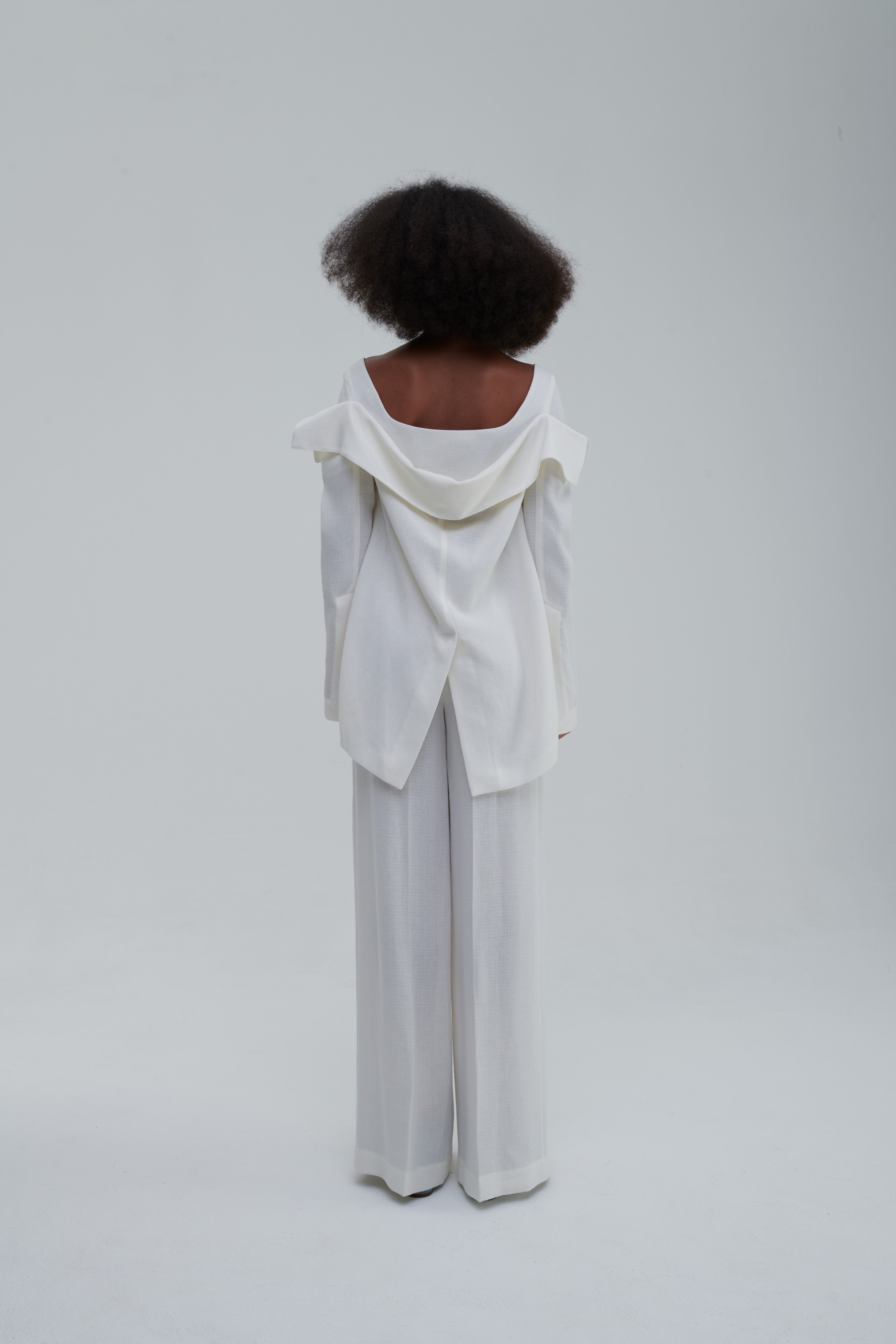 White falling-jacket crop top, back view showing layered shawl collar