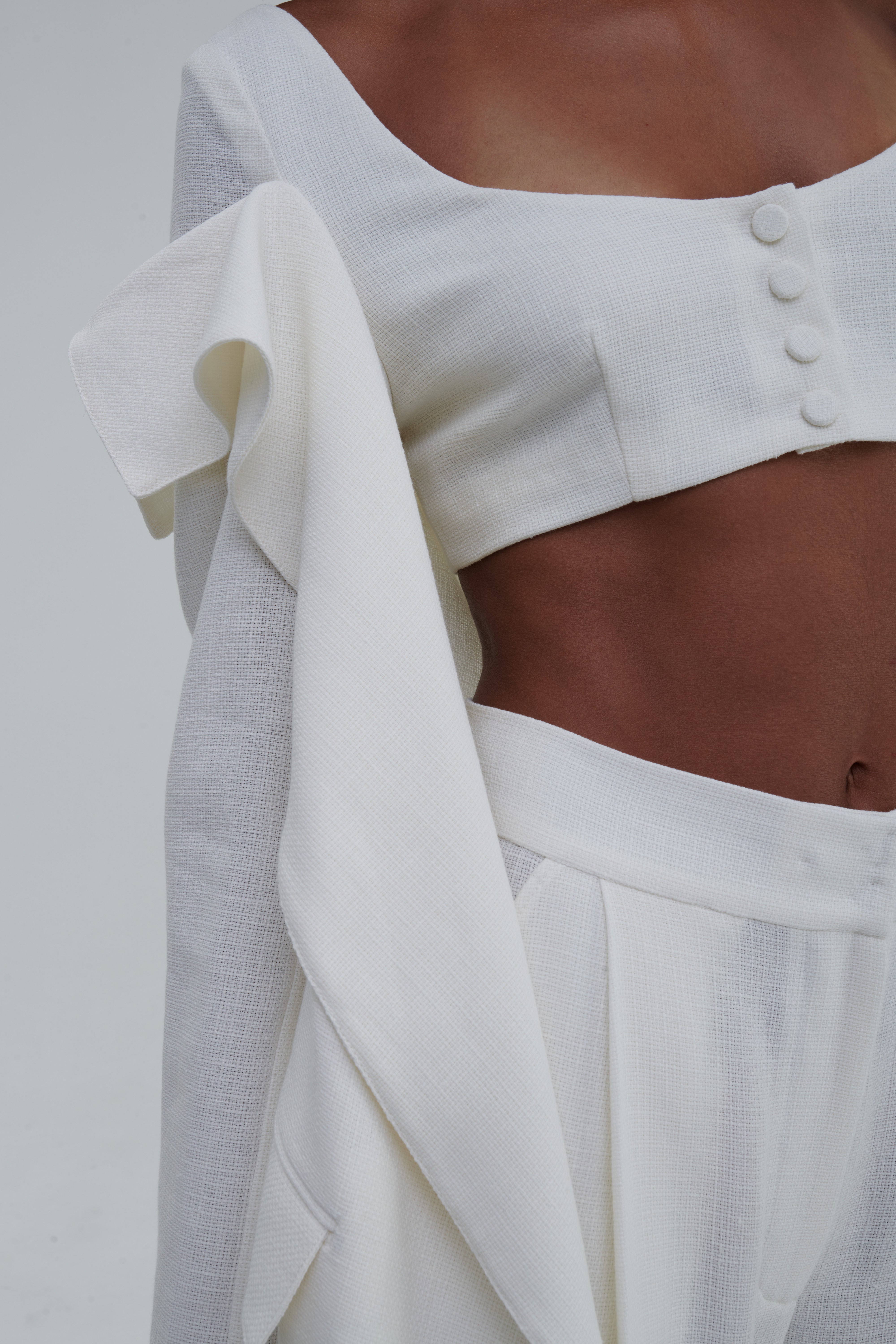 White linen-cotton fabric close-up, waistband and draped lapel detail