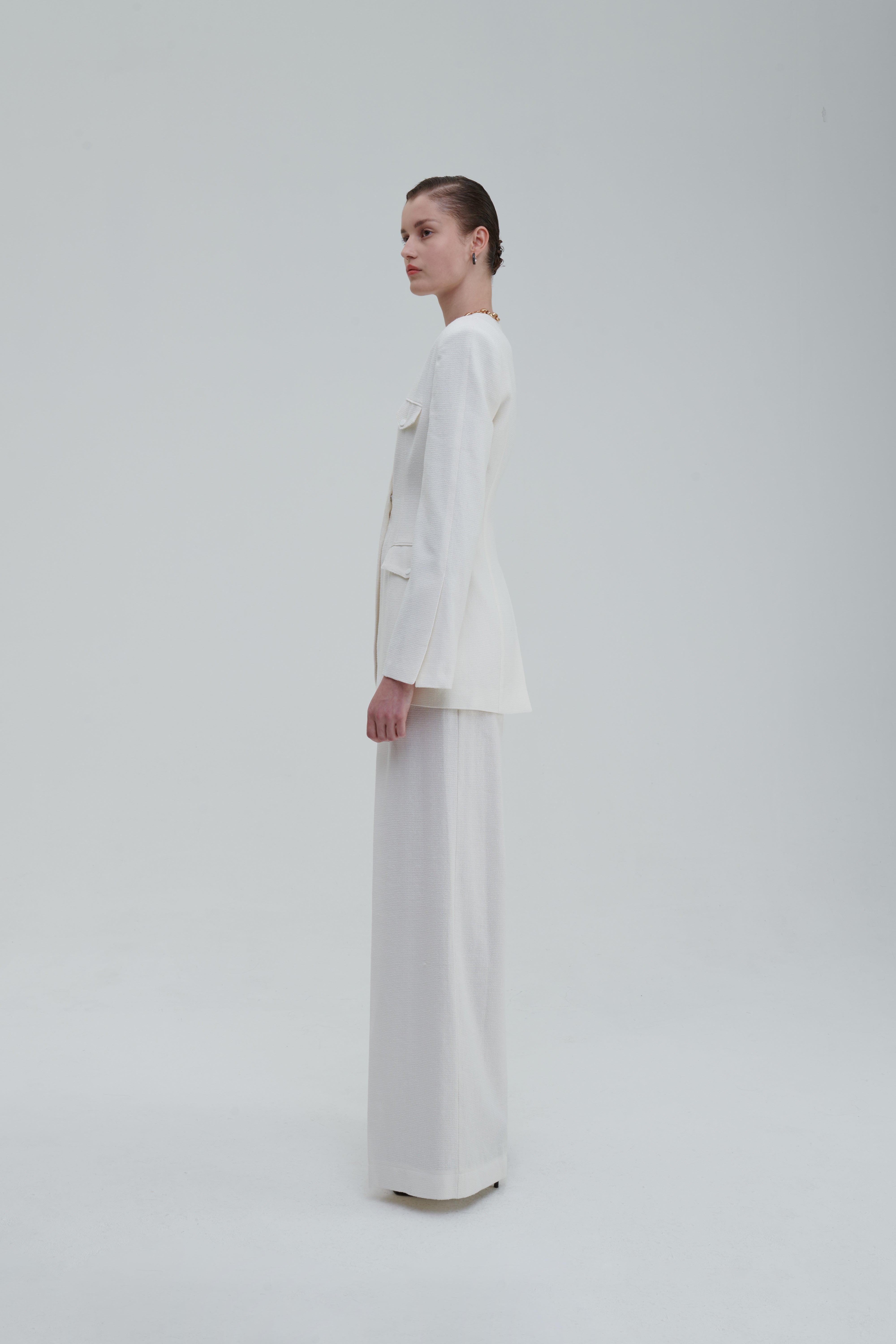 White palazzo trousers with matching blazer, side full-length view