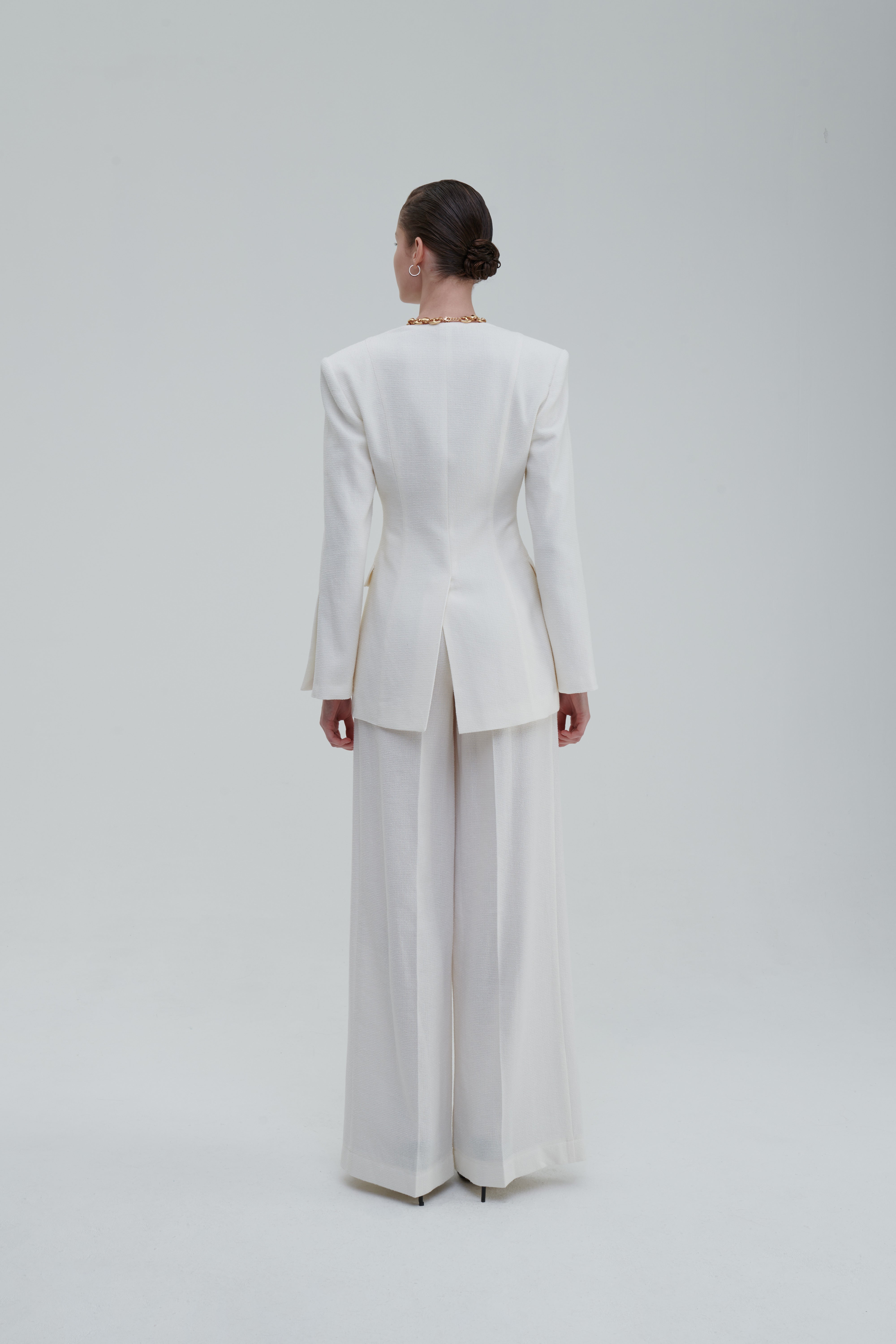 White palazzo trousers with matching blazer, back full-length view