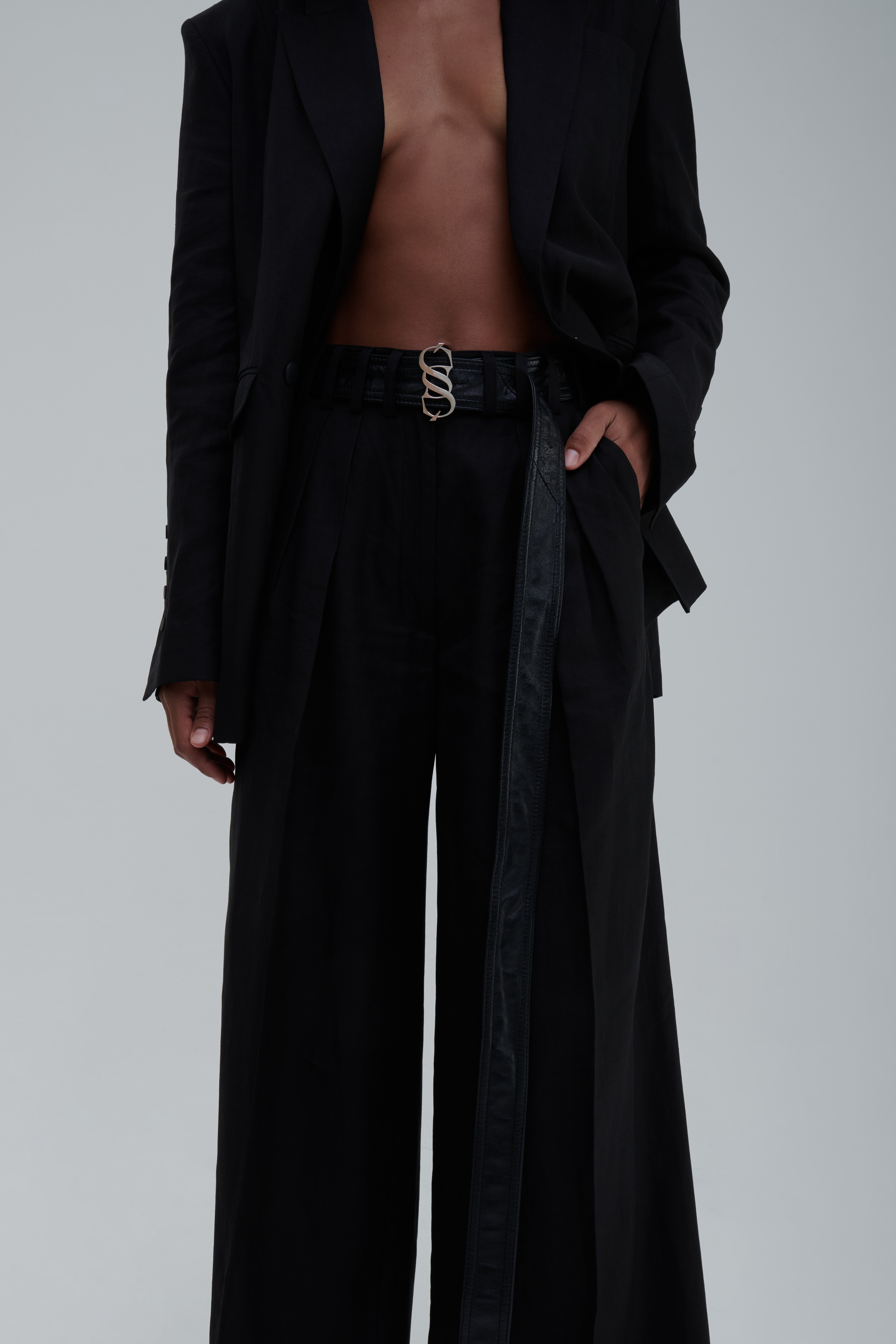 Black high-waist wide-leg trousers, front detail view