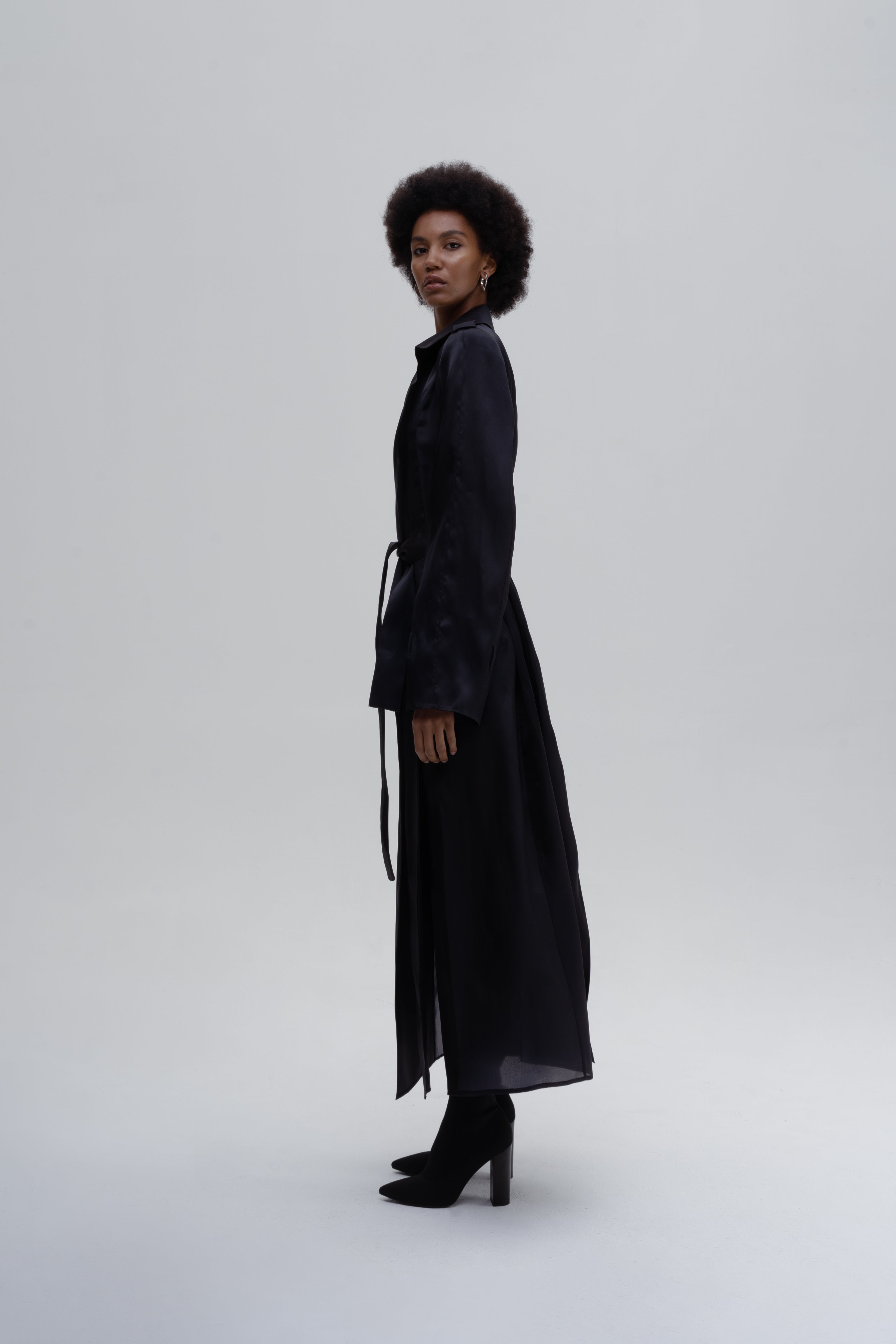 Women’s black silk trench coat with belt, side slits and wide lapels