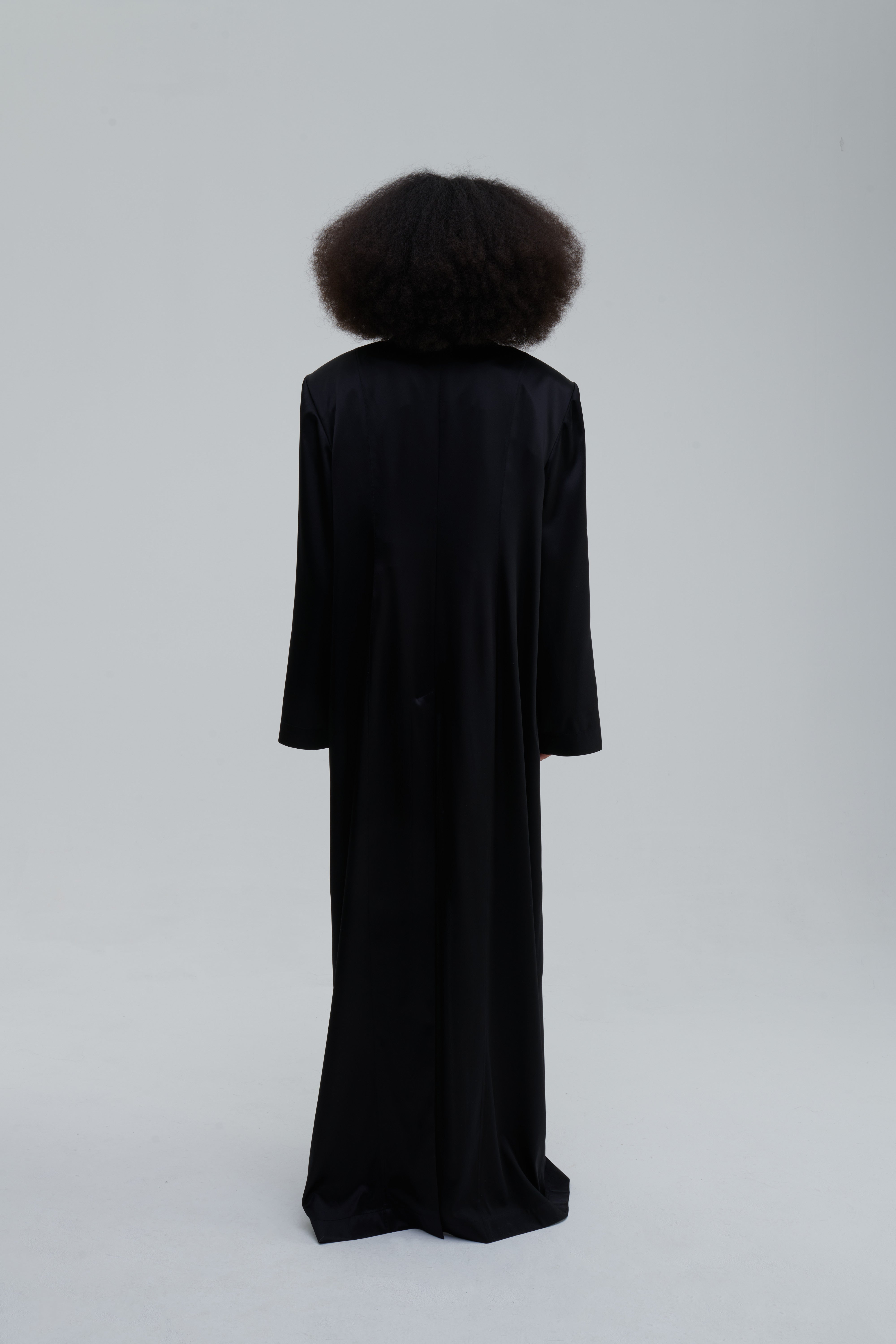 SILK LONG COAT by Sagio from the Spring/Summer 2025 collection — a full-length, flowing silk coat with a minimalist cut, subtle sheen, and relaxed tailored fit. Elegant and lightweight outerwear by thesagio.com