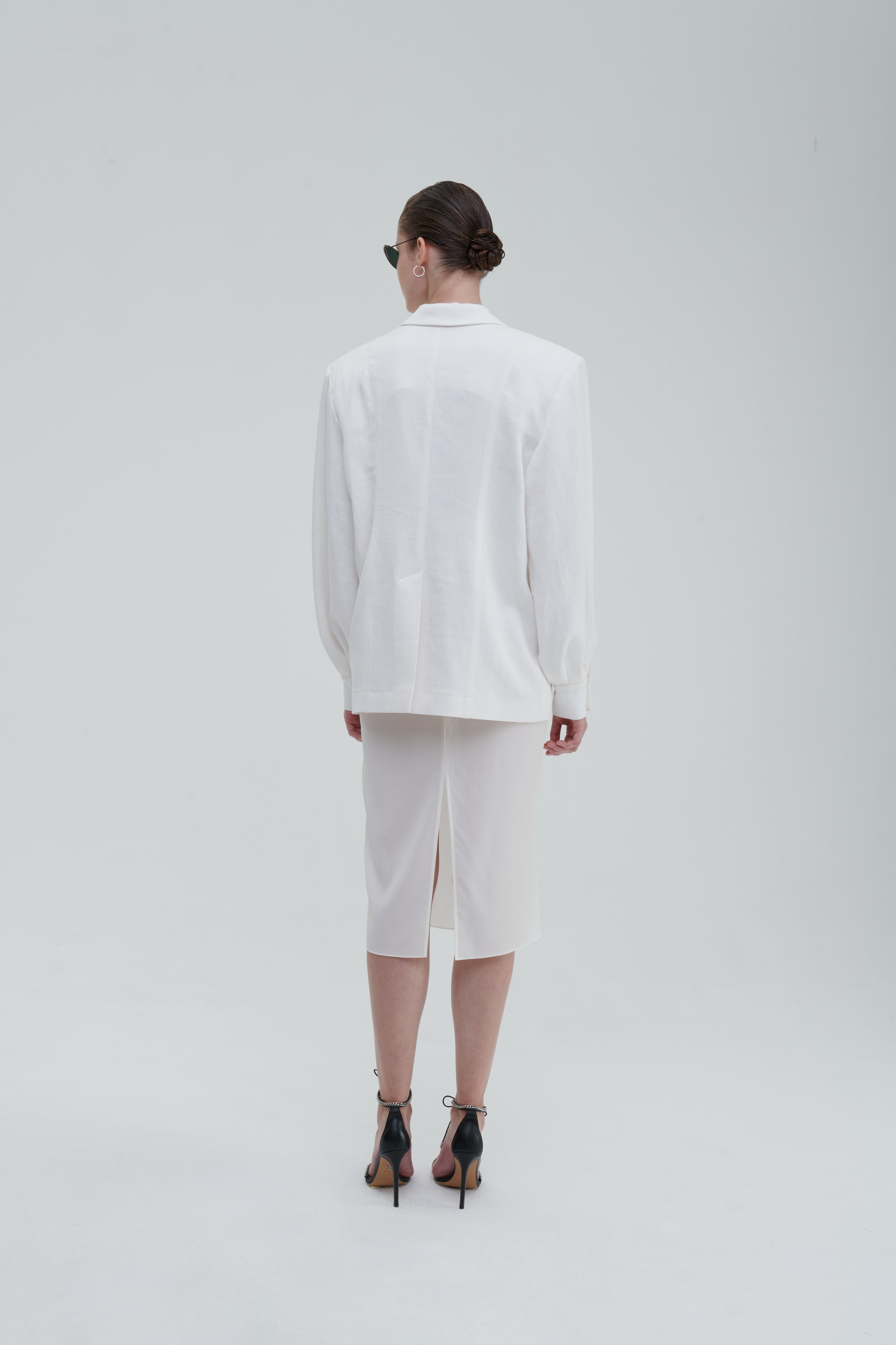 LINO DOUBLE-BREASTED BLAZER by Sagio from the Spring/Summer 2025 collection — a structured, double-breasted linen blazer in natural beige, featuring peak lapels, front pockets, and a refined minimalist silhouette. Discover elevated tailoring at thesagio.com