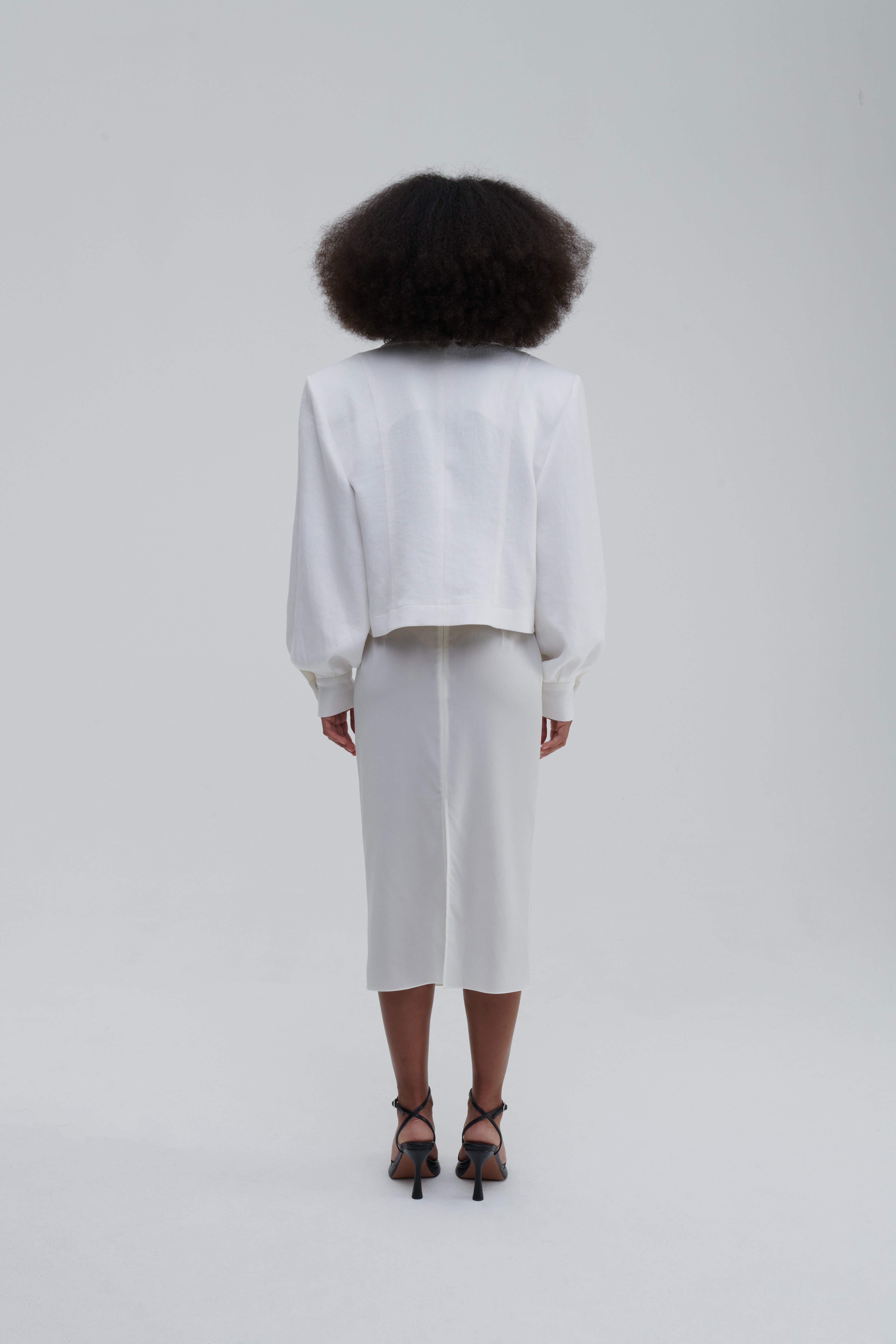 TRANSPARENT SILK SKIRT by Sagio from the Spring/Summer 2025 collection — a sheer, flowing silk maxi skirt in ivory white, designed with soft pleats and ethereal movement. Lightweight and elegant designer womenswear from thesagio.com