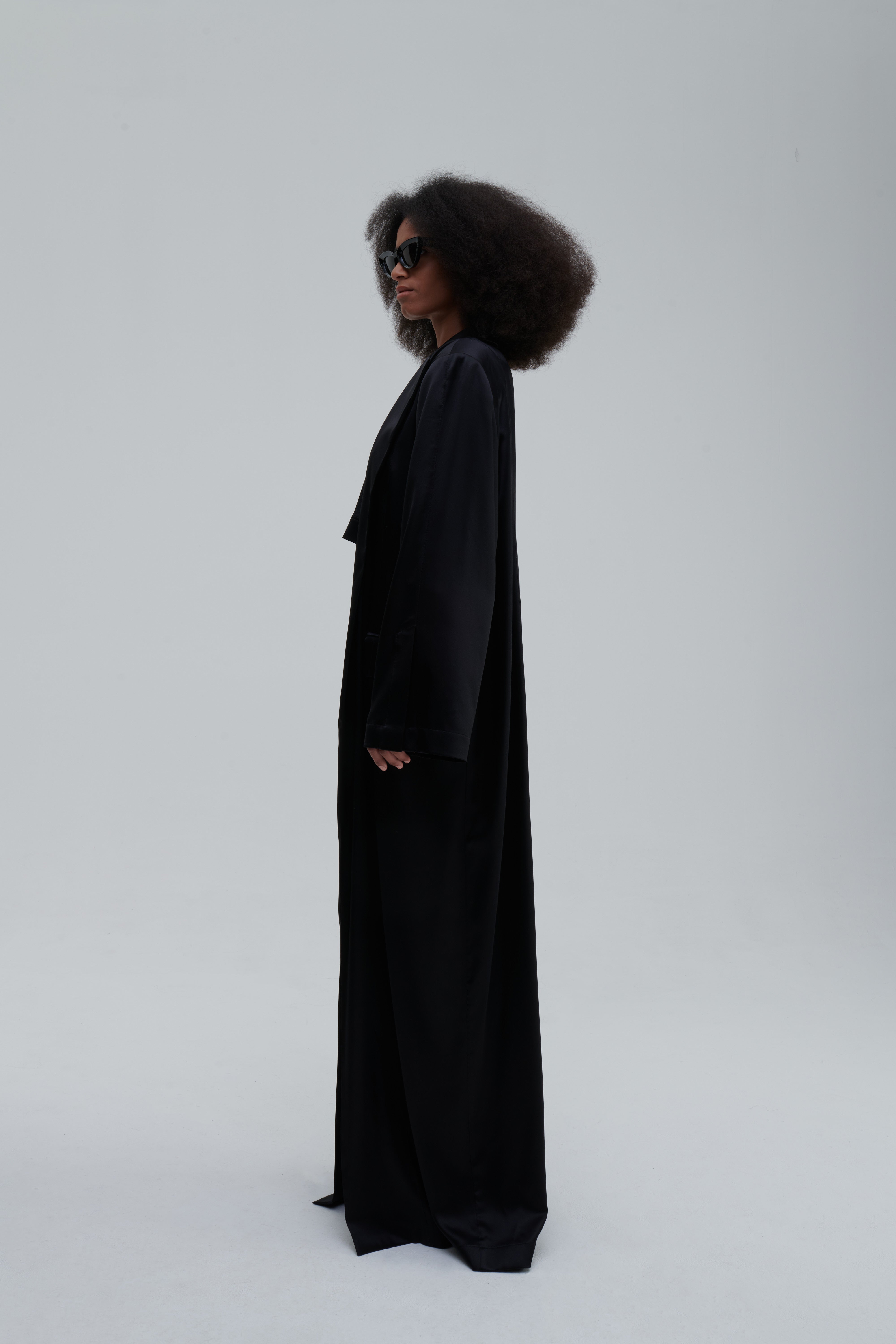 SILK LONG COAT by Sagio from the Spring/Summer 2025 collection — a full-length, flowing silk coat with a minimalist cut, subtle sheen, and relaxed tailored fit. Elegant and lightweight outerwear by thesagio.com