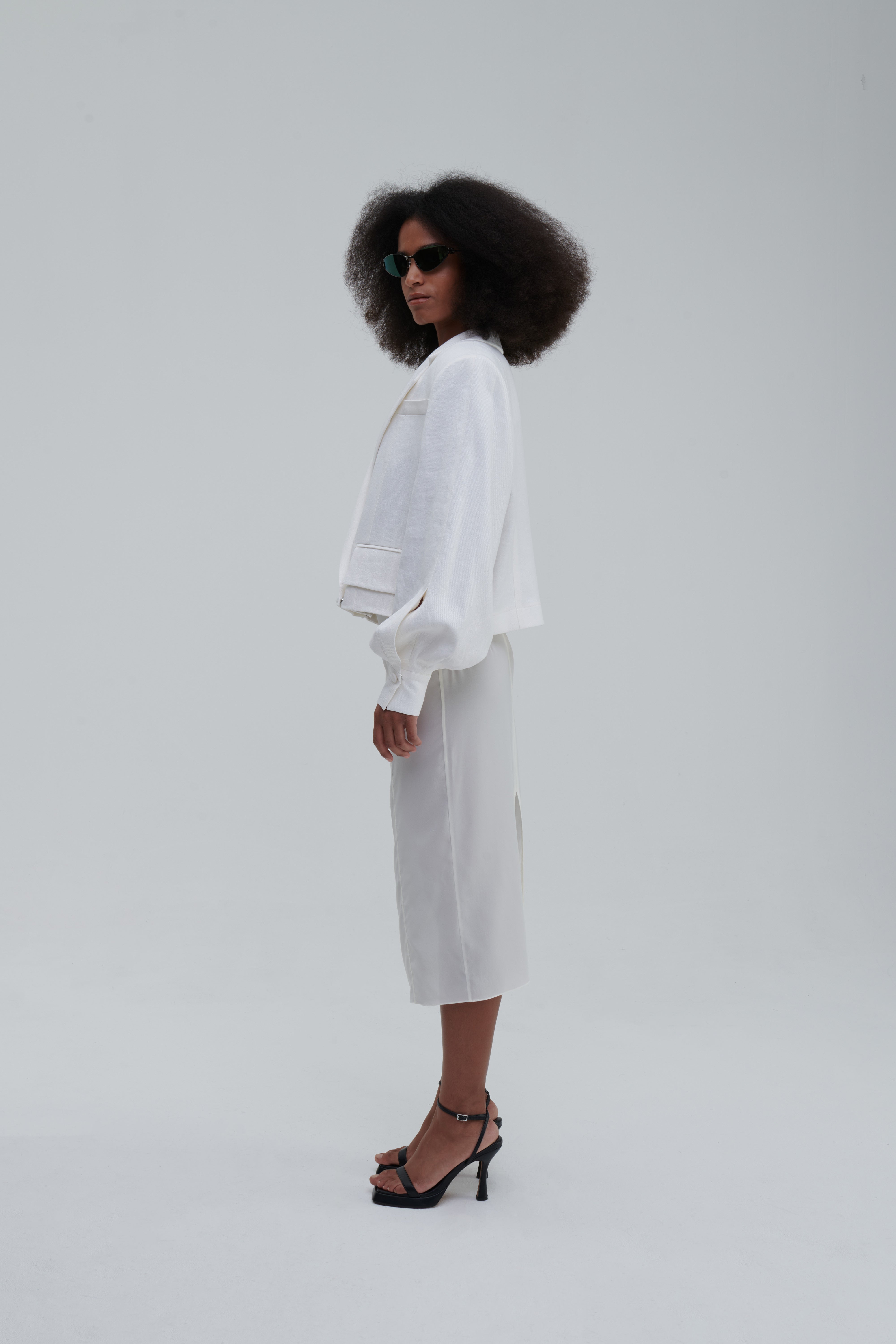 TRANSPARENT SILK SKIRT by Sagio from the Spring/Summer 2025 collection — a sheer, flowing silk maxi skirt in ivory white, designed with soft pleats and ethereal movement. Lightweight and elegant designer womenswear from thesagio.com