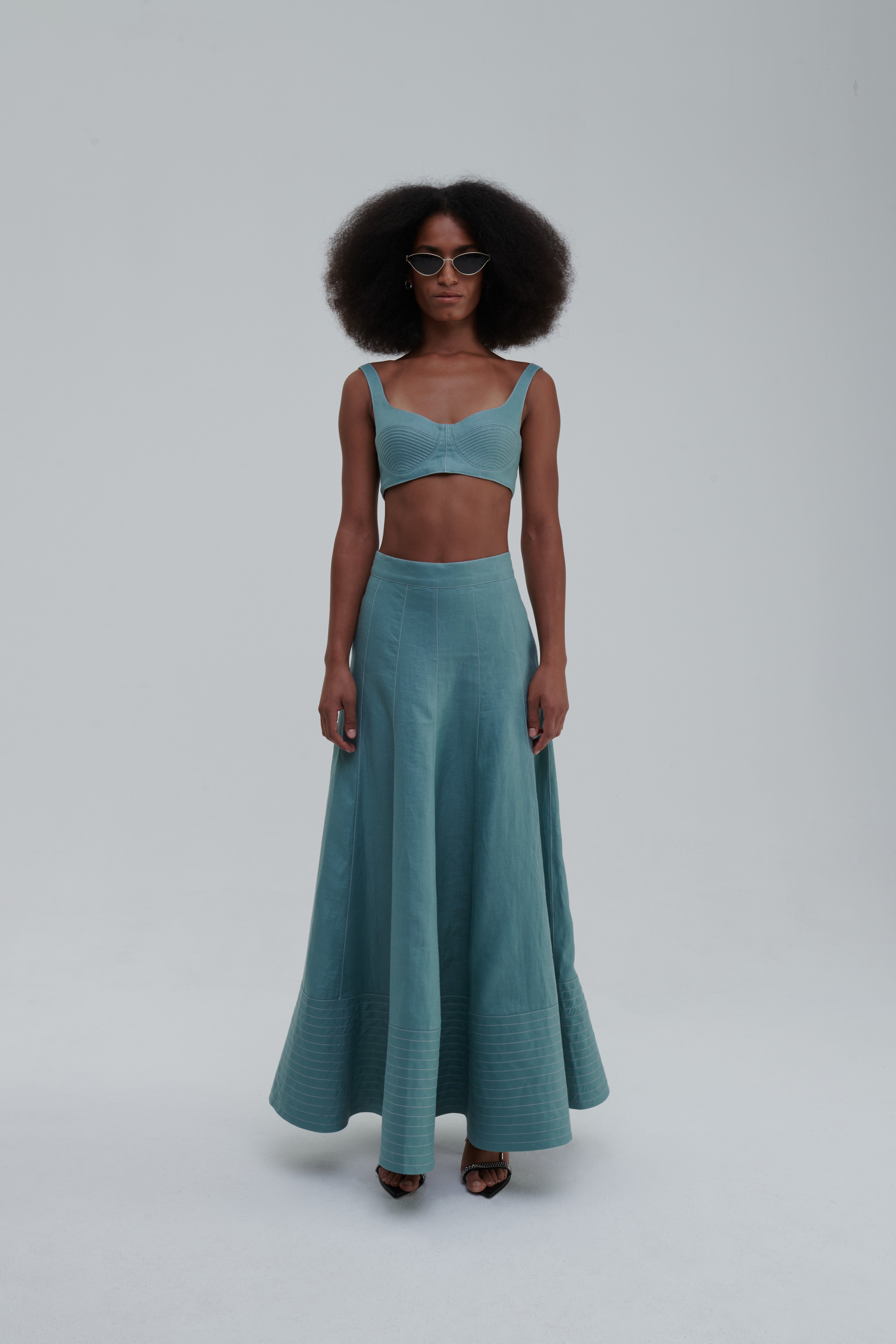 Quilted linen bustier, Green Bay, angled side view on model