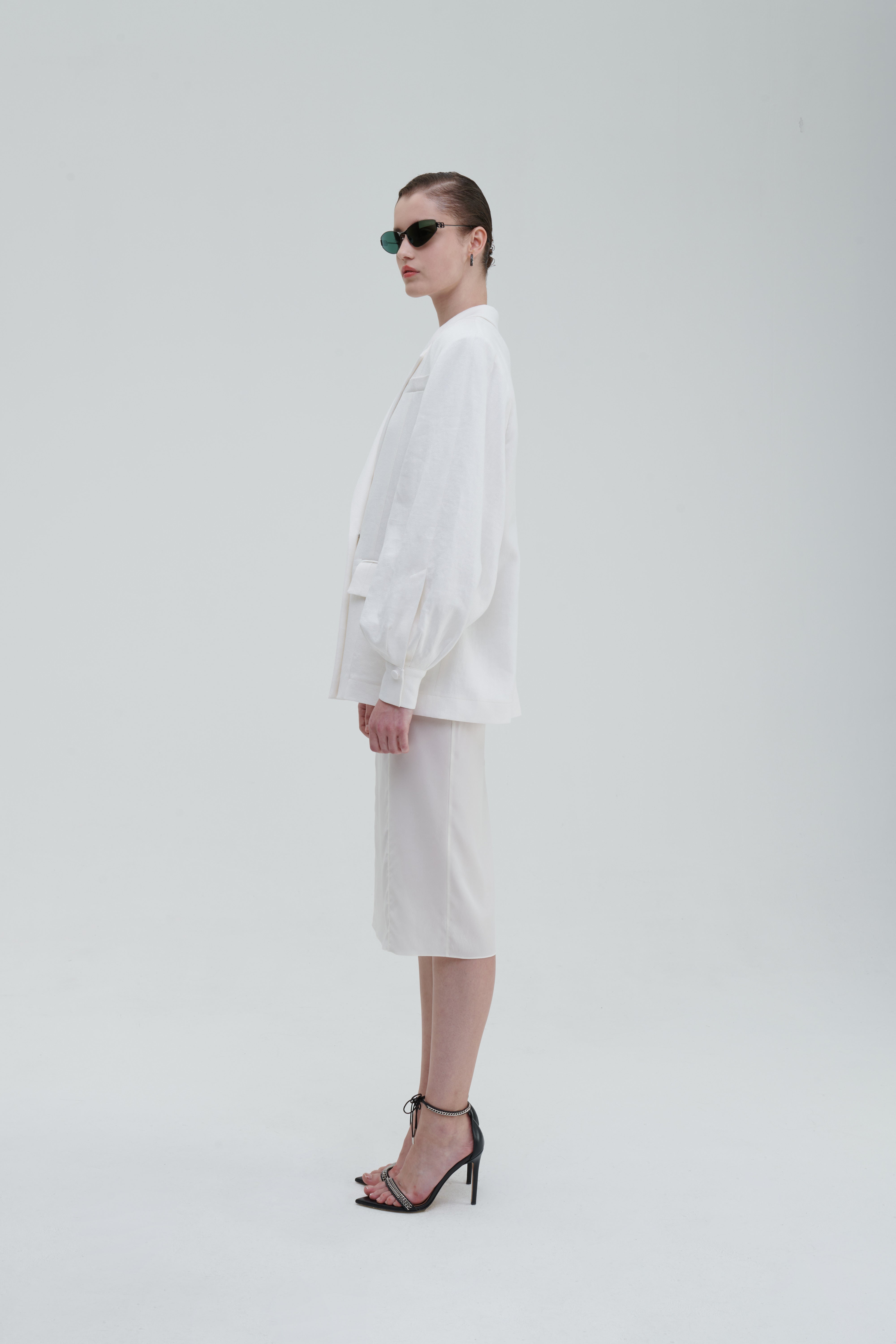 LINO DOUBLE-BREASTED BLAZER by Sagio from the Spring/Summer 2025 collection — a structured, double-breasted linen blazer in natural beige, featuring peak lapels, front pockets, and a refined minimalist silhouette. Discover elevated tailoring at thesagio.com