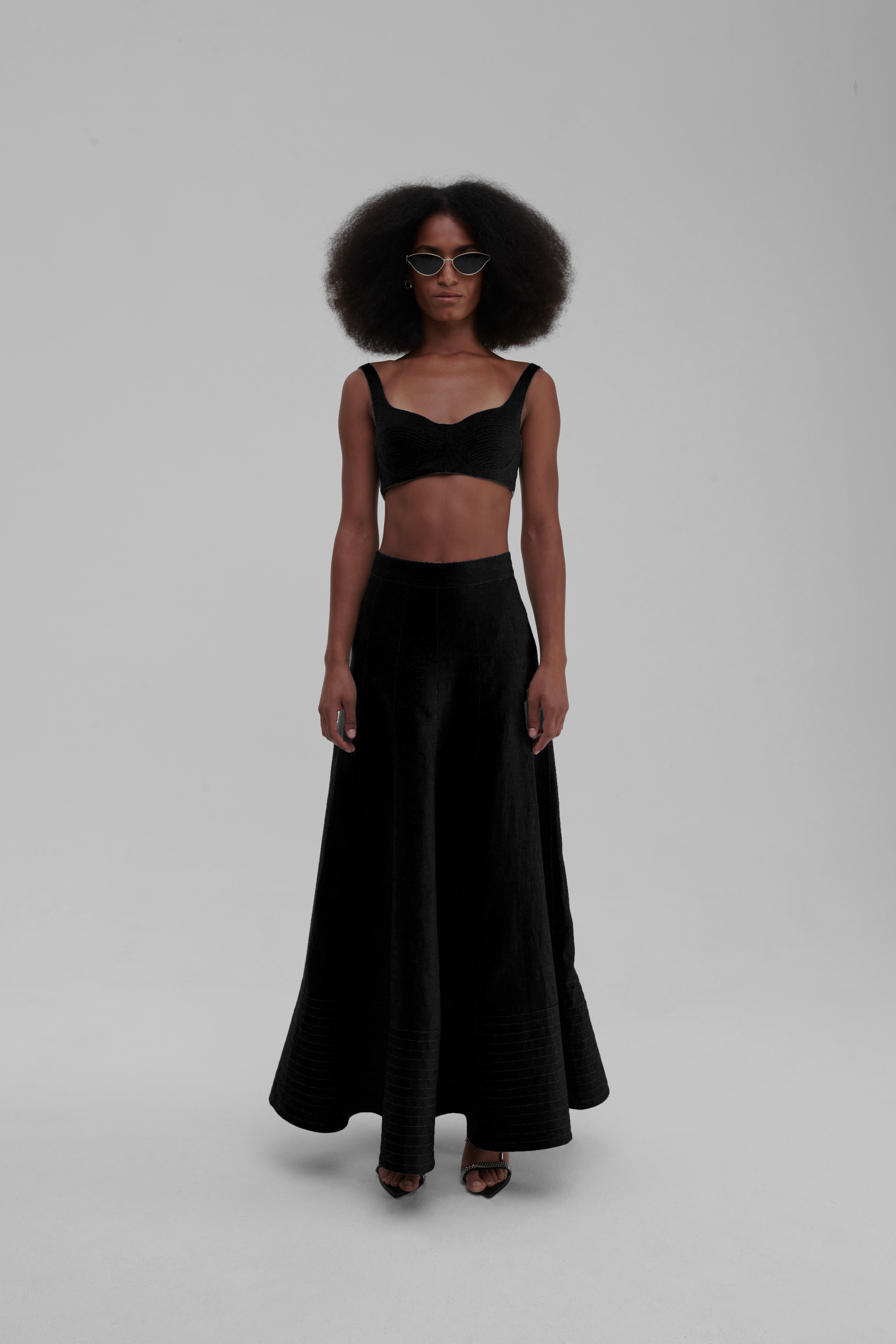 Black linen maxi skirt with quilted hem, front view on-model