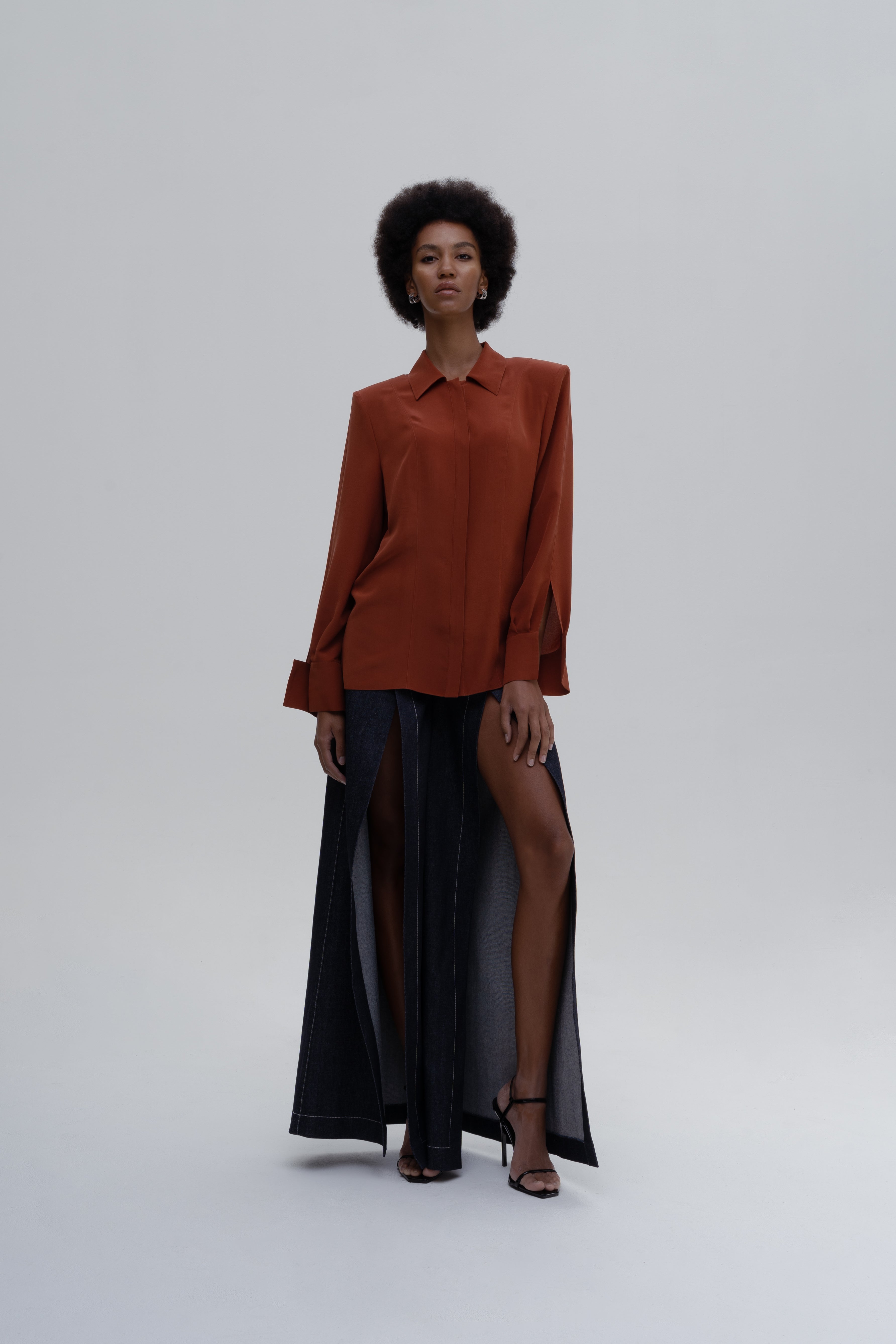 DENIM SLITS TROUSERS by Sagio from the Spring/Summer 2025 collection — wide-leg denim trousers featuring long vertical slits and a structured yet flowing silhouette. A bold, contemporary take on classic denim from thesagio.com