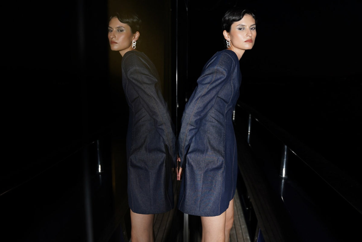 Two models in denim dresses at night
